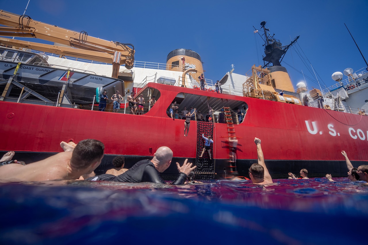 Coast Guardsmen enjoy a swim in the Pacific Ocean.
