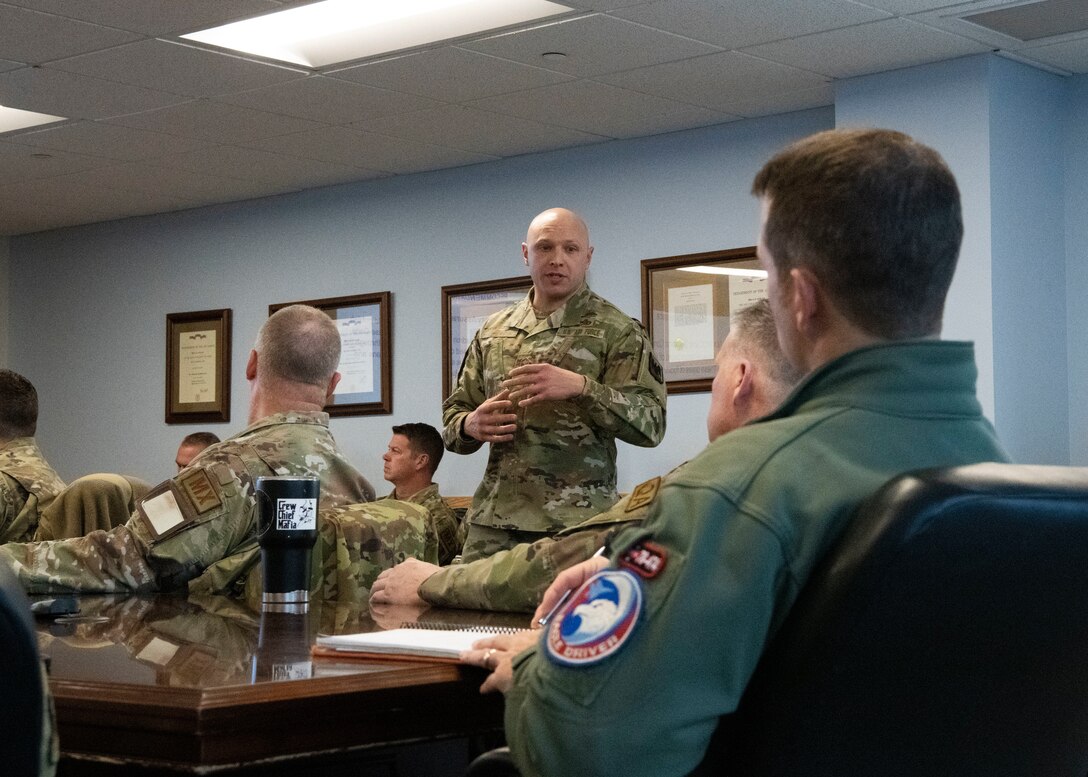 The Air National Guard Production Assessment Team debriefs the 104th Fighter Wing Maintenance Group and Wing leadership on their findings during their week assessing the base, December 16, 2022, at Barnes Air National Guard Base, Massachusetts. The PAT's goal at the 104 FW was to find ways to become more efficient in order to increase aircraft availability. (U.S. Air National Guard Photo by Staff Sgt. Sara Kolinski)