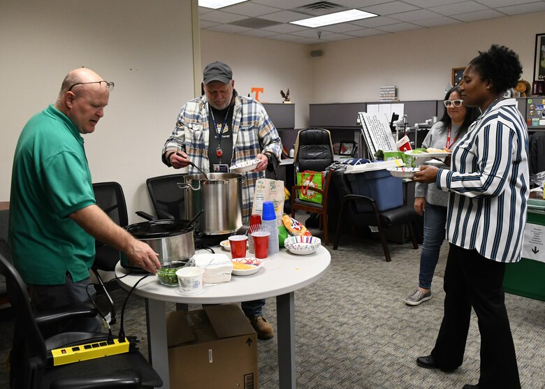 Nashville District employees line up for Public Affairs Specialist Leon Roberts’ famous chili at the Nashville District round-robin Christmas part in Nashville, Tennessee on December 8, 2022.