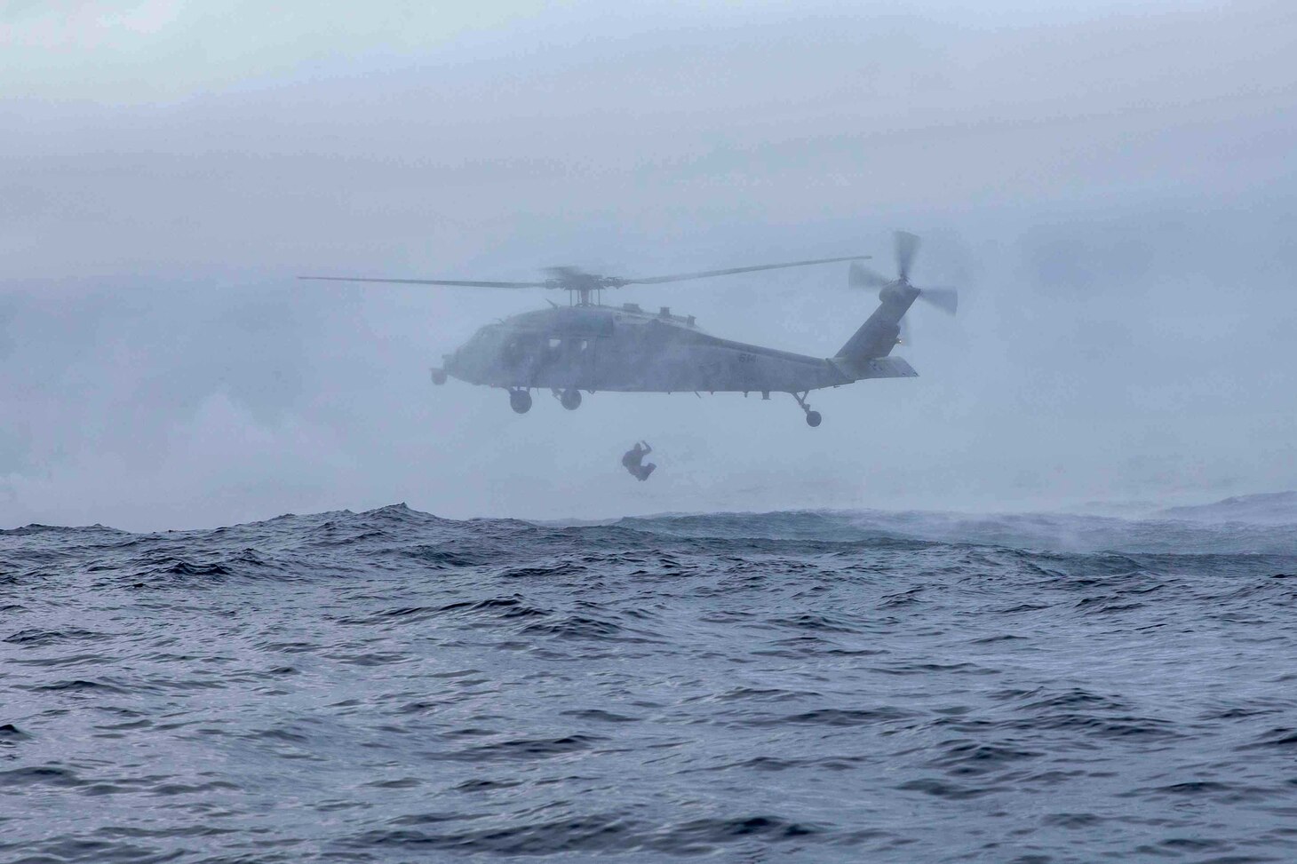 A Sailor assigned to Explosive Ordnance Disposal Mobile Unit 12 jumps from an MH-60S Sea Hawk helicopter, attached to Helicopter Sea Combat Squadron (HSC) 5, during a floating mine response exercise, Dec. 14, 2022. Carrier Air Wing (CVW) 7 is the offensive air and strike component of Carrier Strike Group (CSG) 10, George H.W. Bush CSG. The squadrons of CVW-7 are Strike Fighter Squadron (VFA) 86, VFA-103, VFA-136, VFA-143, Electronic Attack Squadron (VAQ) 140, Carrier Airborne Early Warning Squadron (VAW) 121, HSC-5, and Helicopter maritime Strike Squadron (HSM) 46. The George H.W. Bush CSG is on a scheduled deployment in the U.S. Naval Forces Europe area of operations, employed by U.S. Sixth Fleet to defend U.S., allied and partner interests.