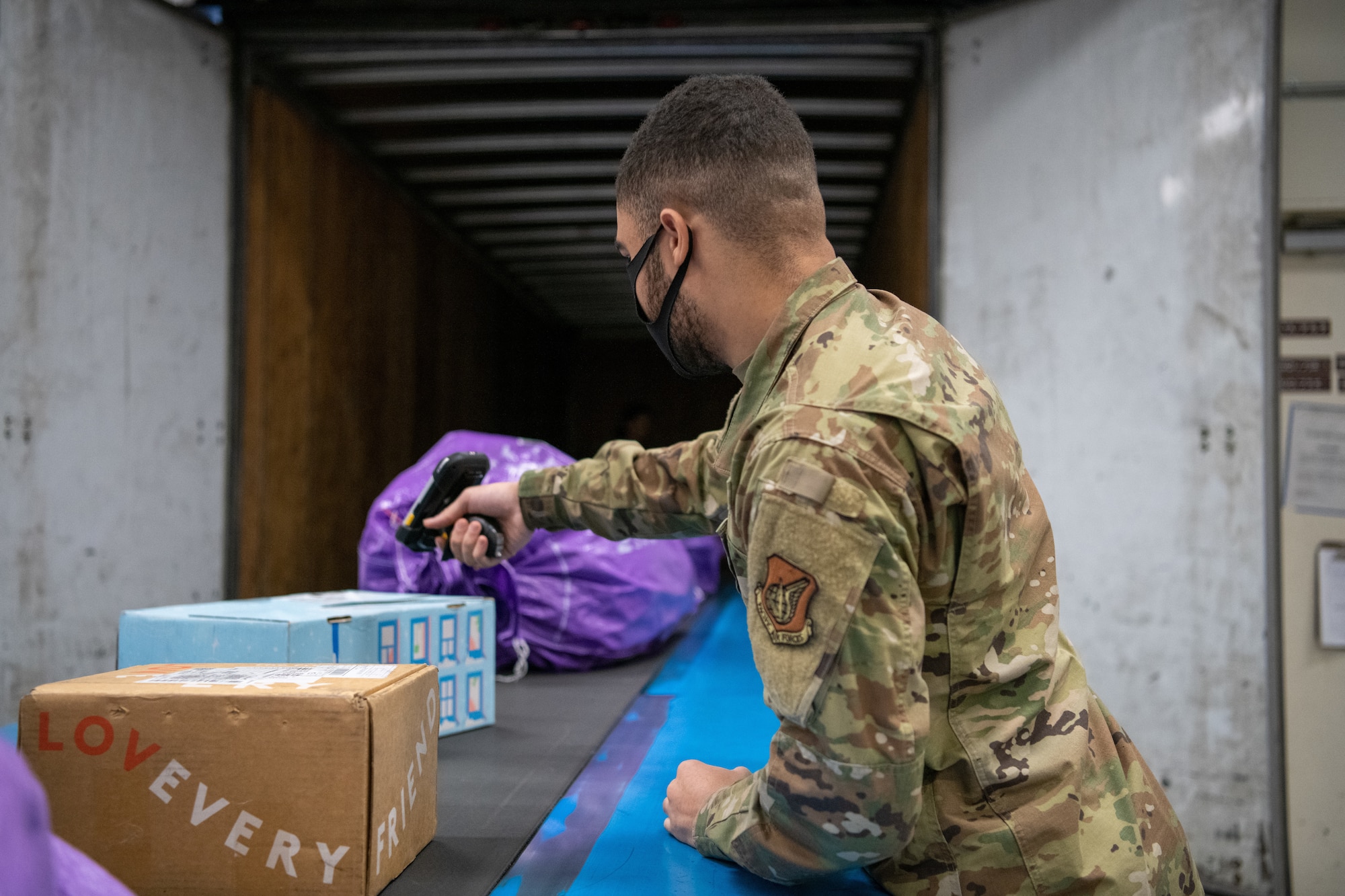 A mail processing clerk scans mail for accountability