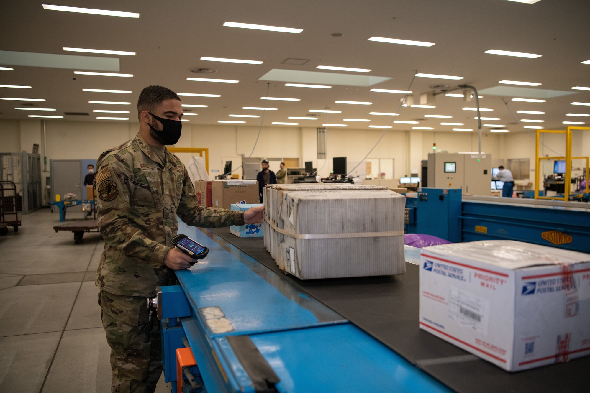 A mail processing clerk scans mail for accountability