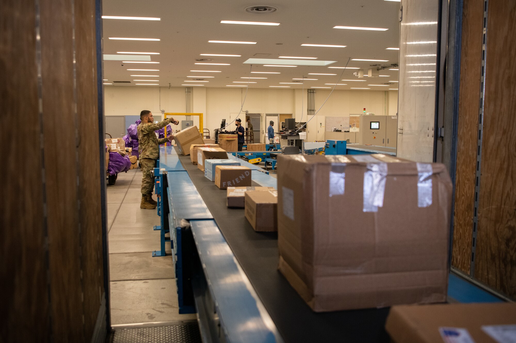 A mail processing clerk scans mail for accountability