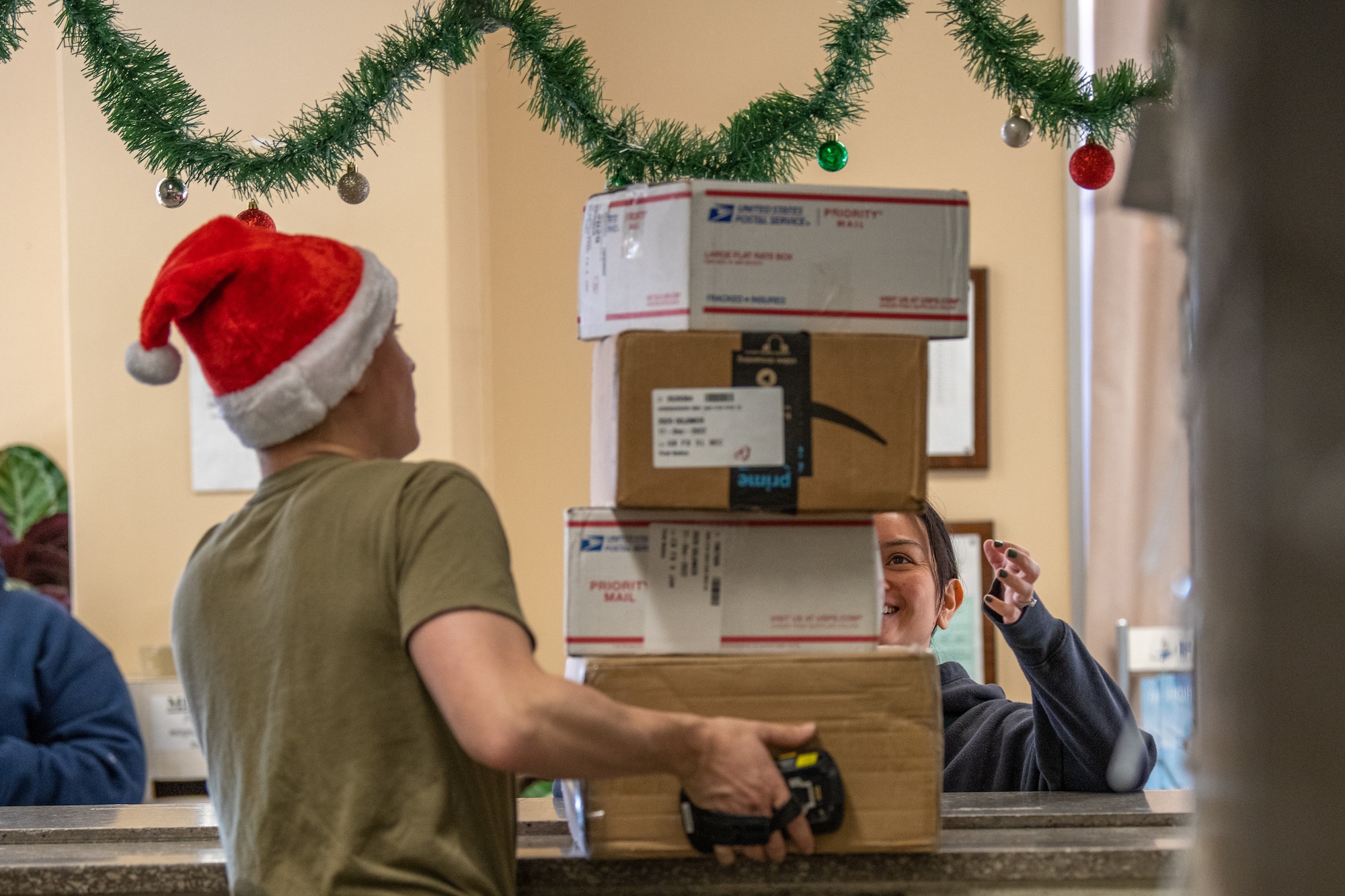 A volunteer postal clerk delivers packages to a Yokota resident