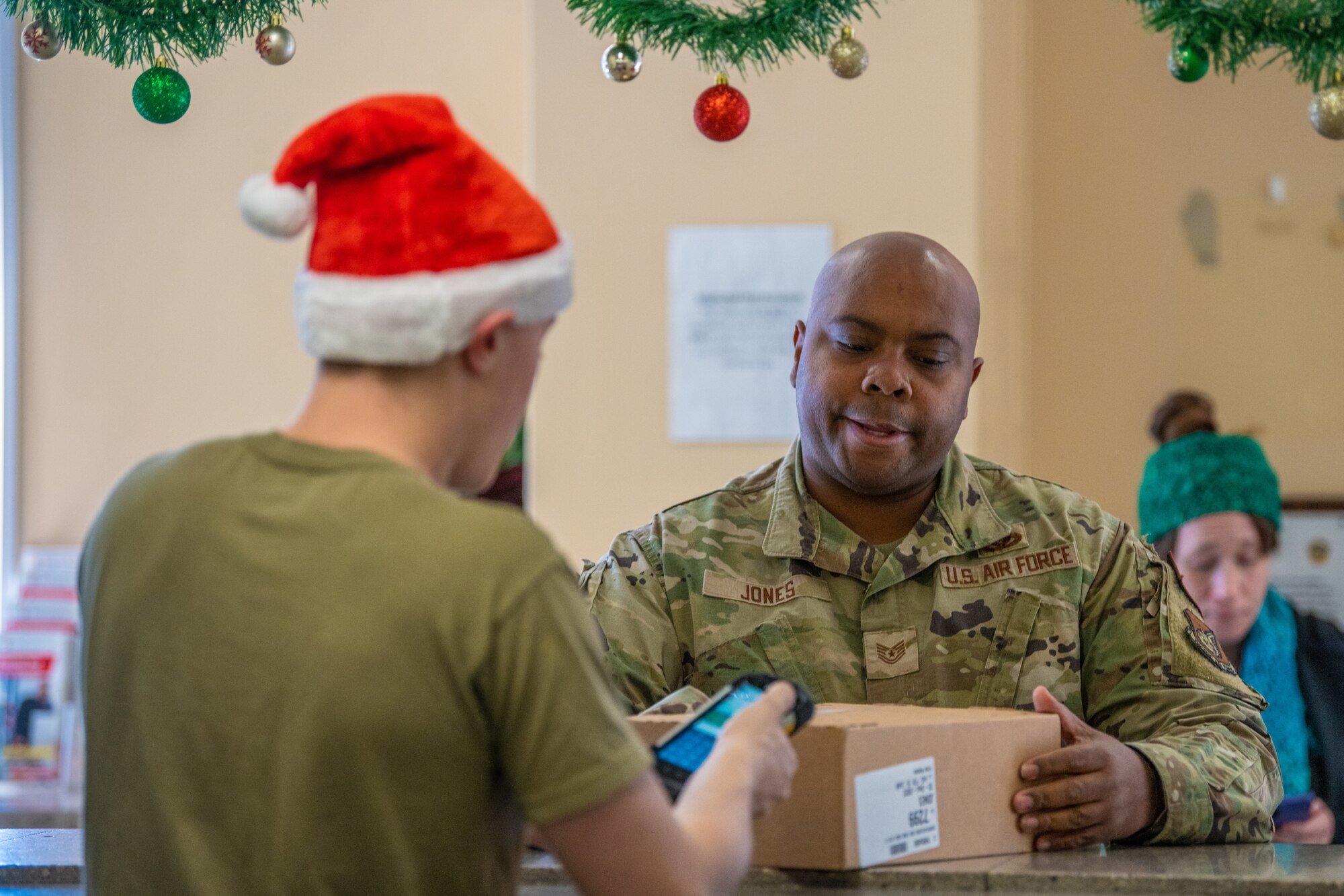 A volunteer postal clerk delivers a package to a Yokota resident