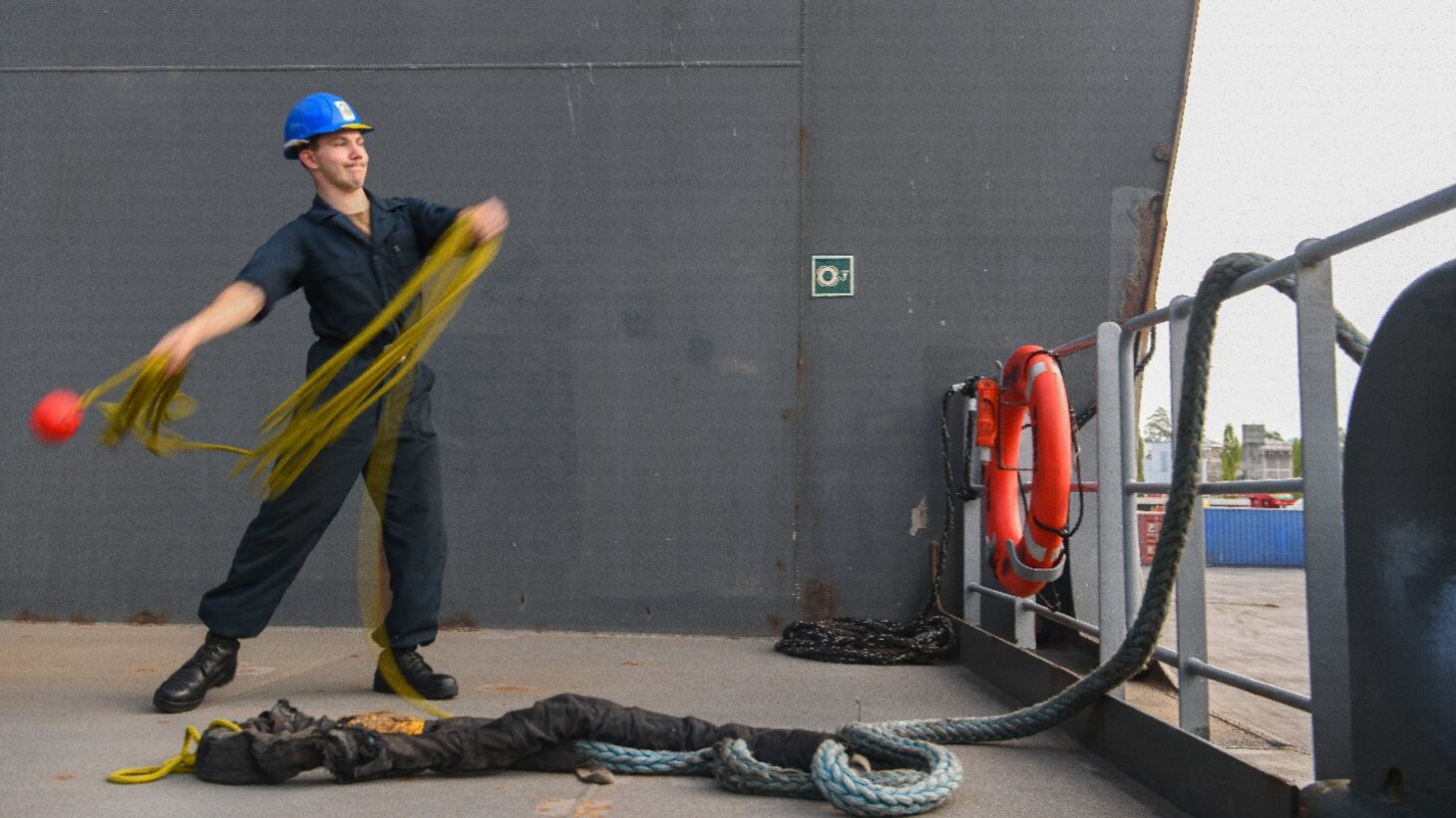 Seaman Dominick Frere, from Phelps, N.Y., heaves line as the expeditionary sea base USS Hershel "Woody" Williams (ESB 4), moors pier side in Dar es Salaam, Tanzania for a scheduled port visit, Dec. 22, 2022.