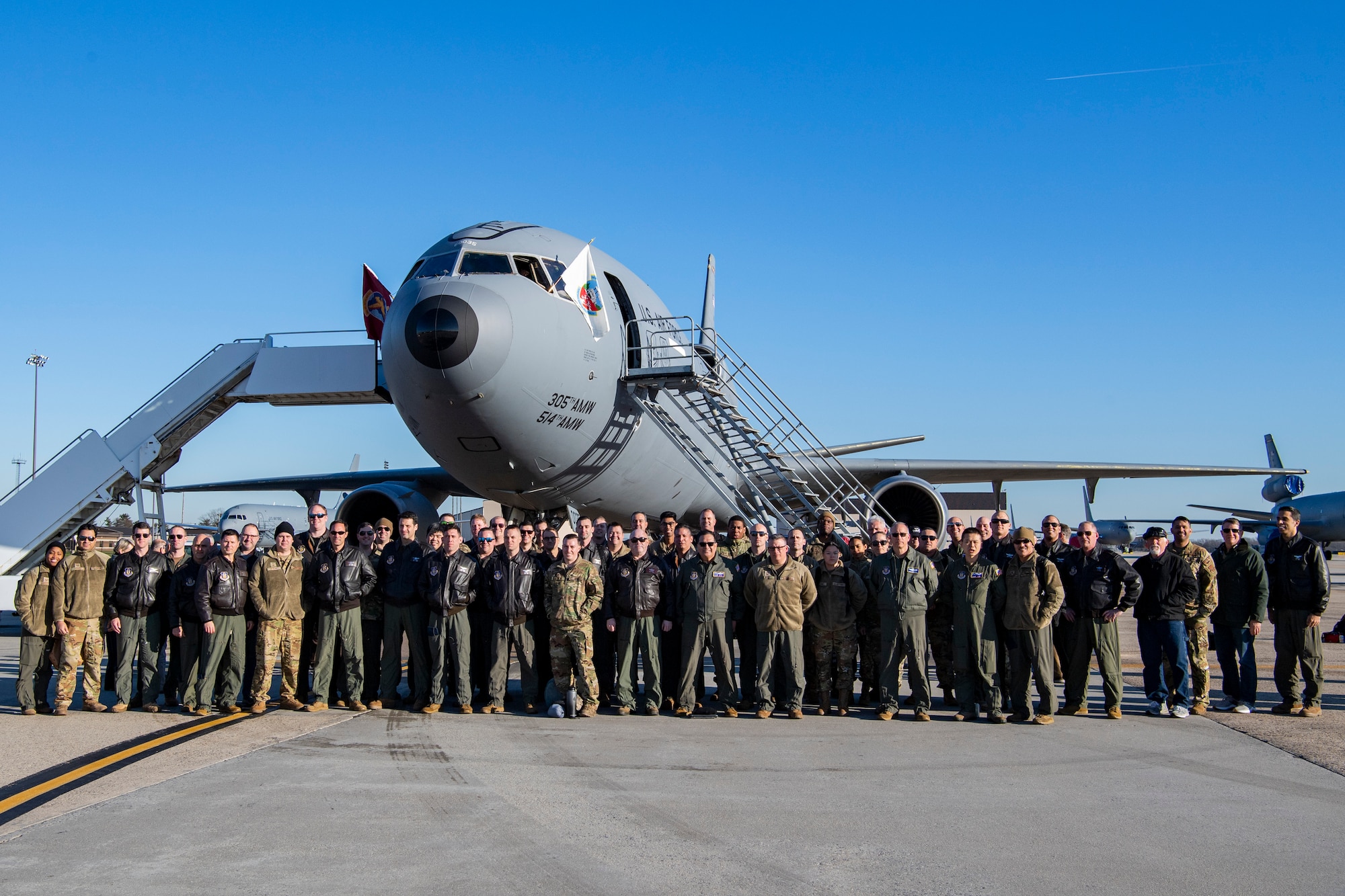 U.S. Reserve Citizen Airmen with the 514th Air Mobility Wing pose for a photo with a KC-10 Extender at Joint Base McGuire-Dix-Lakehurst, 0n Dec. 21, 2022. the 514 AMW crewed its final KC-10 flight as the wing transitions toward the KC-46A Pegasus for air refuel, cargo, and troop transport capabilities.