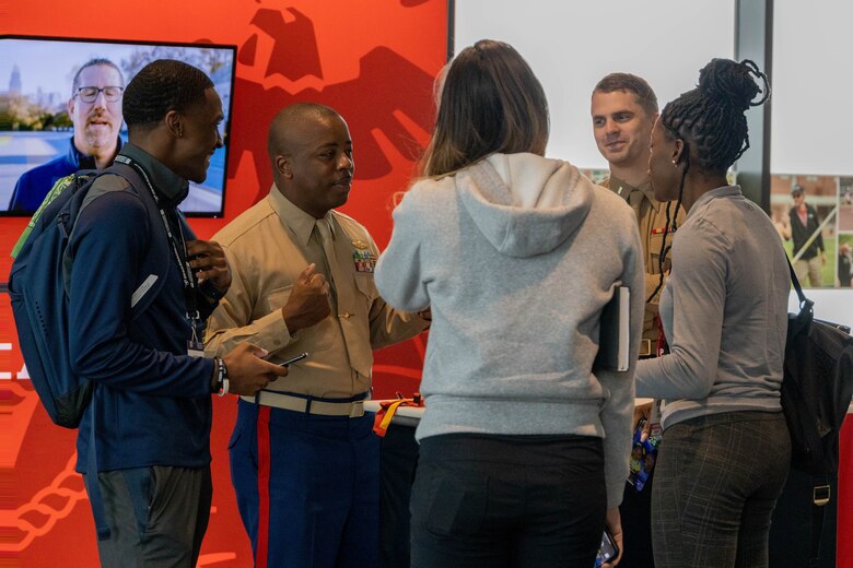 U.S. Marine Corps Master Sgt. Christopher McComb, 3rd Force Reconnaissance Company communications chief, and 1st Lt. Benjamin Biedrzycki, Marine Corps Recruiting Command national partnership officer, speak with coaches at the United States Track & Field and Cross-Country Coaches Association Convention in Aurora, Colo., Dec. 13, 2022. MCRC is proud to partner with USTFCCCA, during the convention Marines were able to network, participate in professional development sessions with coaches and celebrate the National High School Coaches of the year. (U.S. Marine Corps photo by Lance Cpl. Jennifer Sanchez)