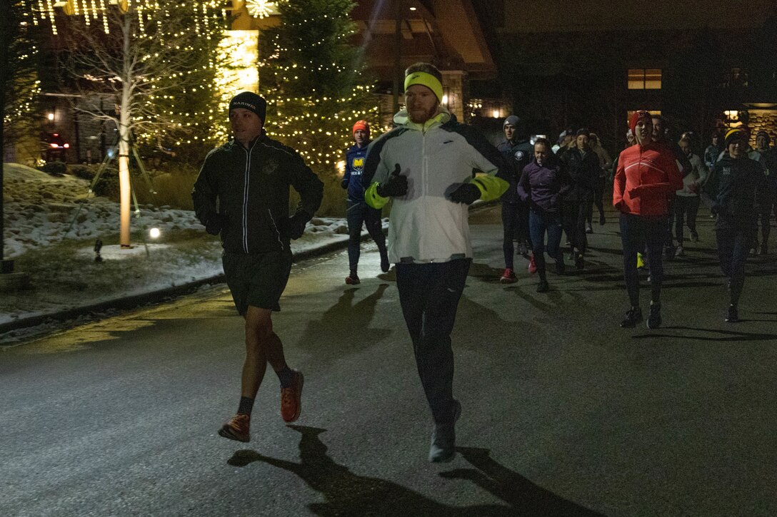 U.S. Marine Corps Michael Wood, an occupational field manager with the Judge Advocate Division, Headquarters, Marine Corps, leads a 2-mile morning run with the coaches during the United States Track & Field and Cross-Country Coaches Association Convention in Aurora, Colo., Dec. 14, 2022. The Marine Corps Recruiting Command is proud to partner with USTFCCCA, during the convention Marines were able to network, participate in professional development sessions with coaches and celebrate the National High School Coaches of the year. (U.S. Marine Corps photo by Lance Cpl. Jennifer Sanchez)