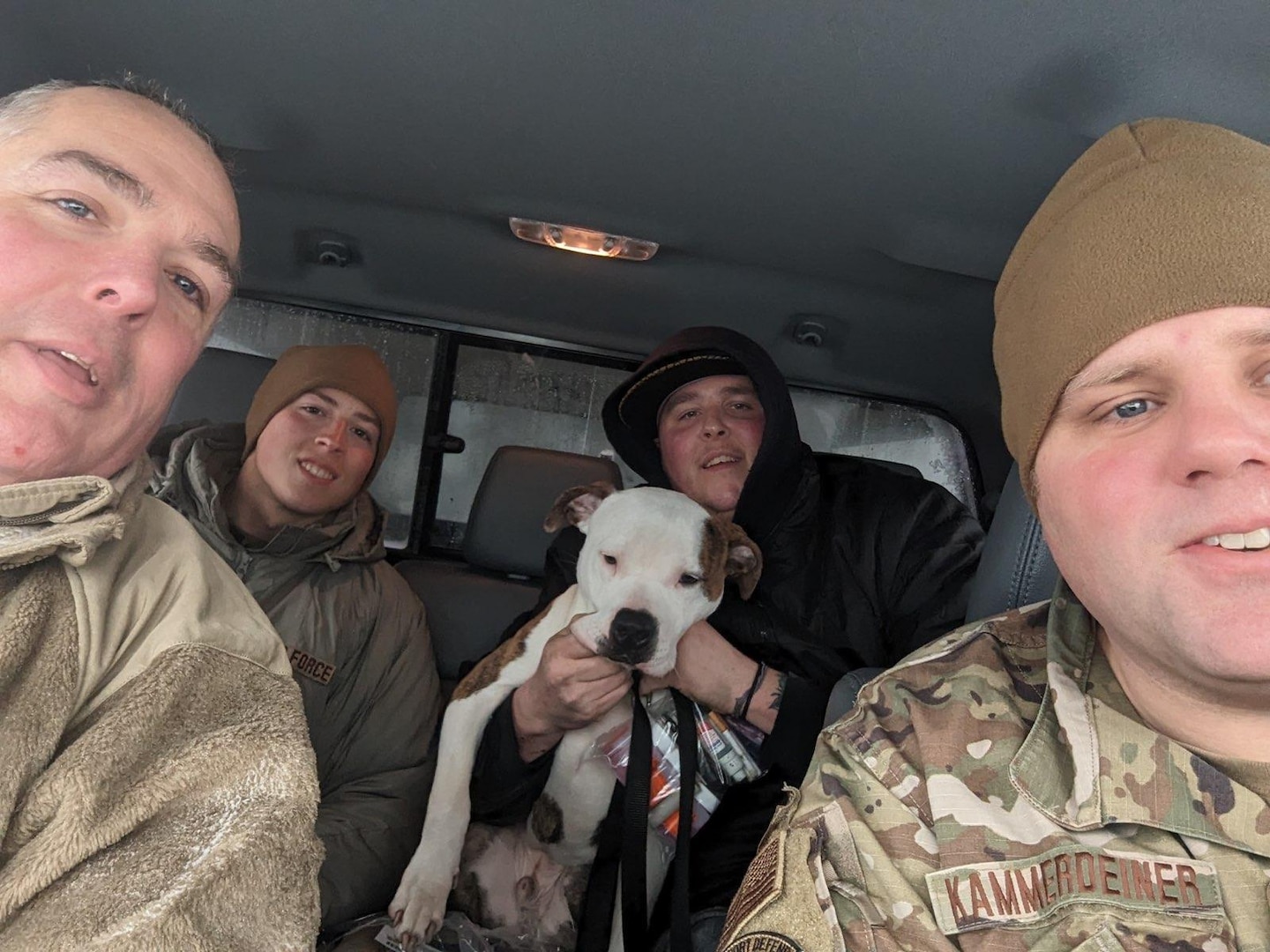 New York Air National Guard Airmen assigned to the 107th Attack Wing at Niagara Falls rescue a motorist and his dog from high snow drifts near Buffalo, New York, Dec. 24, 2022, during a blizzard.
