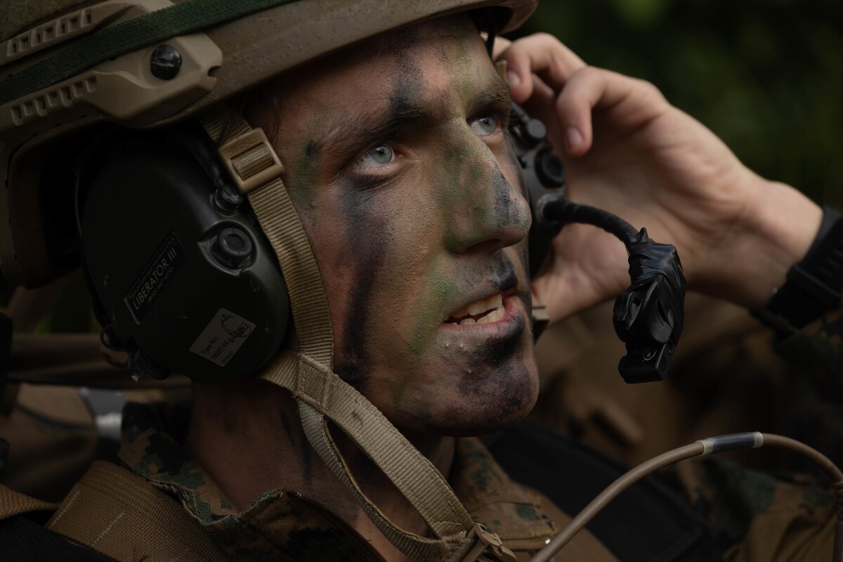 A Marine is shown close up with camouflage face paint.