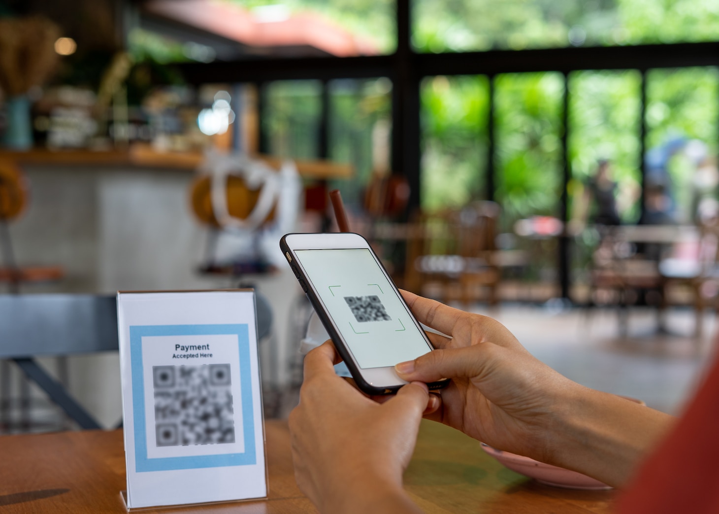 Stock image of a person using a smart-phone to access a web site via QR Code