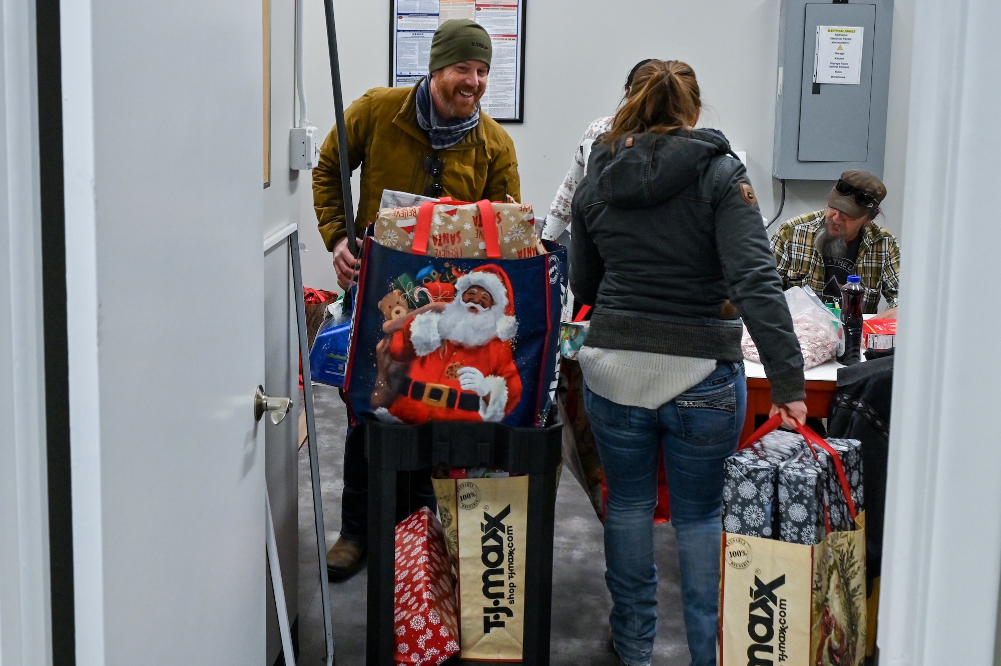David Cook, 90th Contracting Squadron contracting specialist, drops off presents for local families in need as part of Needs Inc Adopt a Family Program in Cheyenne, Wyoming, Dec 19, 2022. 90 CONS came together for the second year in a row to support two families in need, so they did not have to choose between giving their kids food or celebrating the holiday season. (U.S. Air Force photo by Joseph Coslett Jr.)