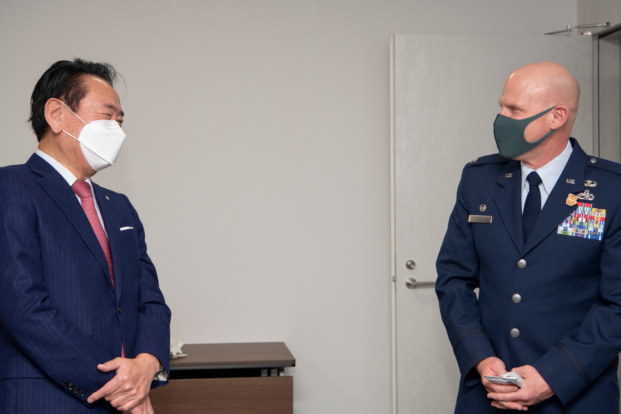 Col. Philip Dorsch, 374th Maintenance Group commander, shares a laugh with Hiroyuki Sugiura, mayor of the Mizuho town, at the Mizuho Town Hall, Dec. 22, 2022