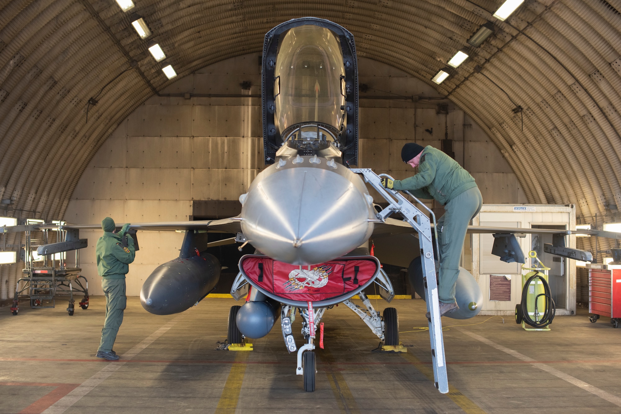 German Luftwaffe members inspect an F-16.