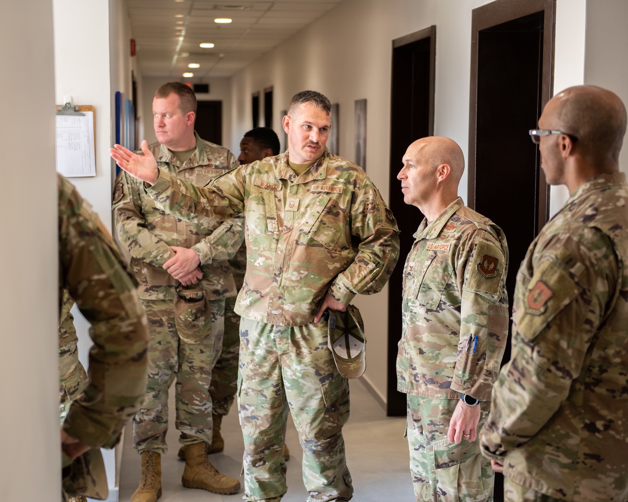 Master Sgt. Wesley Walker, 39th Maintenance Squadron munitions materiel flight chief, shows Col. Calvin Powell, 39th Air Base Wing commander, the entranceway of the new munitions flight building after the 39th MXS munitions flight building dedication ceremony at Incirlik Air Base, Türkiye, Dec. 19, 2022. The 39th MXS munitions flight building was designed to provide a streamlined means of communication within the ammunitions flight and assist Airmen in building camaraderie and teamwork. The building also provides better protection for munitions assets controlled by the flight and consolidates six sections into a single building, increasing productivity for current and future Airmen. (U.S. Air Force photo by Senior Airman David D. McLoney)