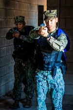 Master-at-Arms 3rd Class Cristian Delgado and Master-at-Arms 3rd Class Sean Smith respond to an incident during a security drill at Naval Station (NAVSTA) Rota, Dec 27, 2022.