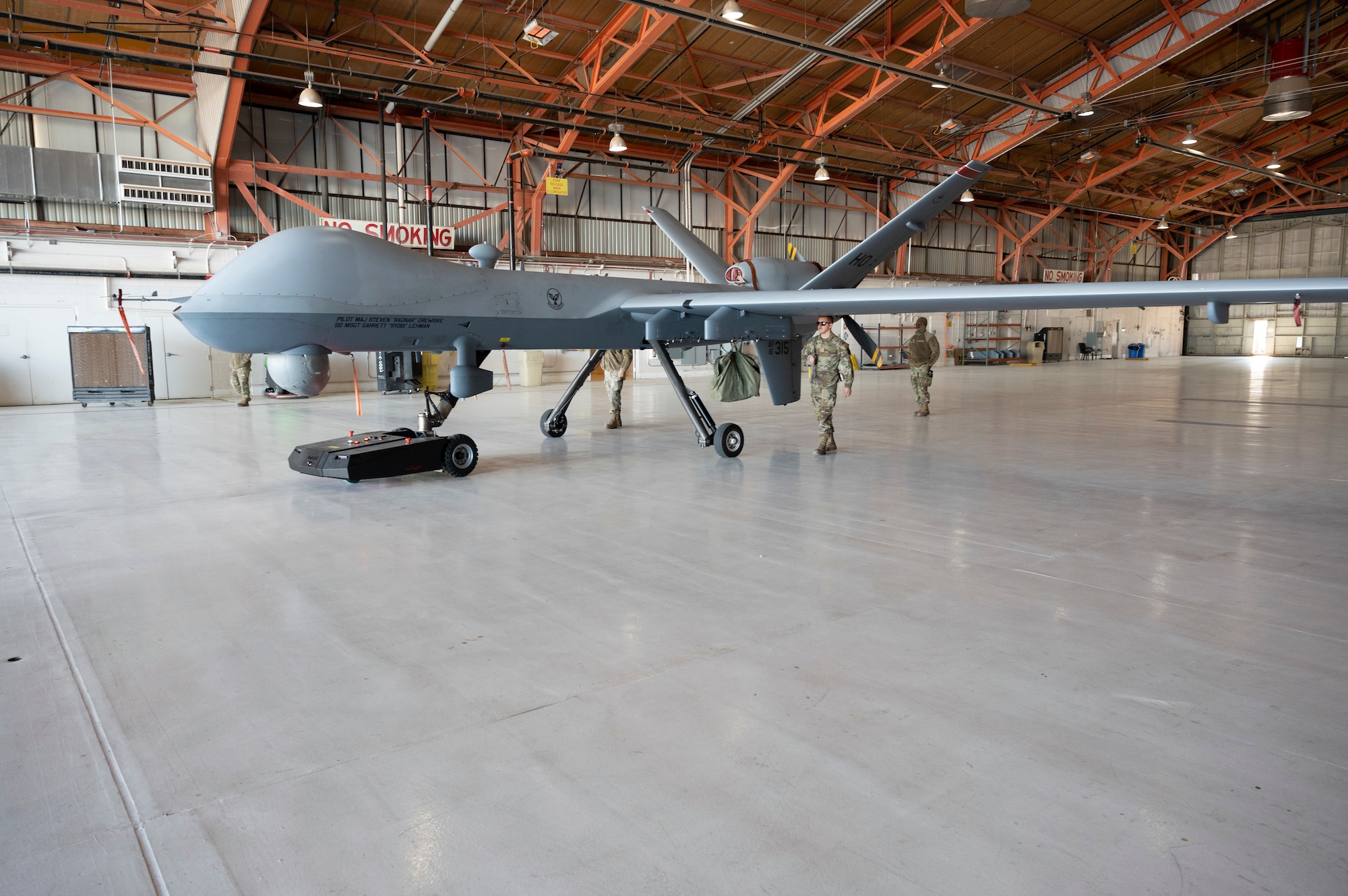A TowFLEXX TF3 aircraft tug tows an MQ-9 Reaper at Holloman Air Force Base, New Mexico, Dec. 15, 2022. The TF3 is a remote-controlled aircraft tug which allows the operator to maneuver aircraft 360 degrees, easily and efficiently moved by maintenance personnel. (U.S. Air Force photo by Airman 1st Class Isaiah Pedrazzini)
