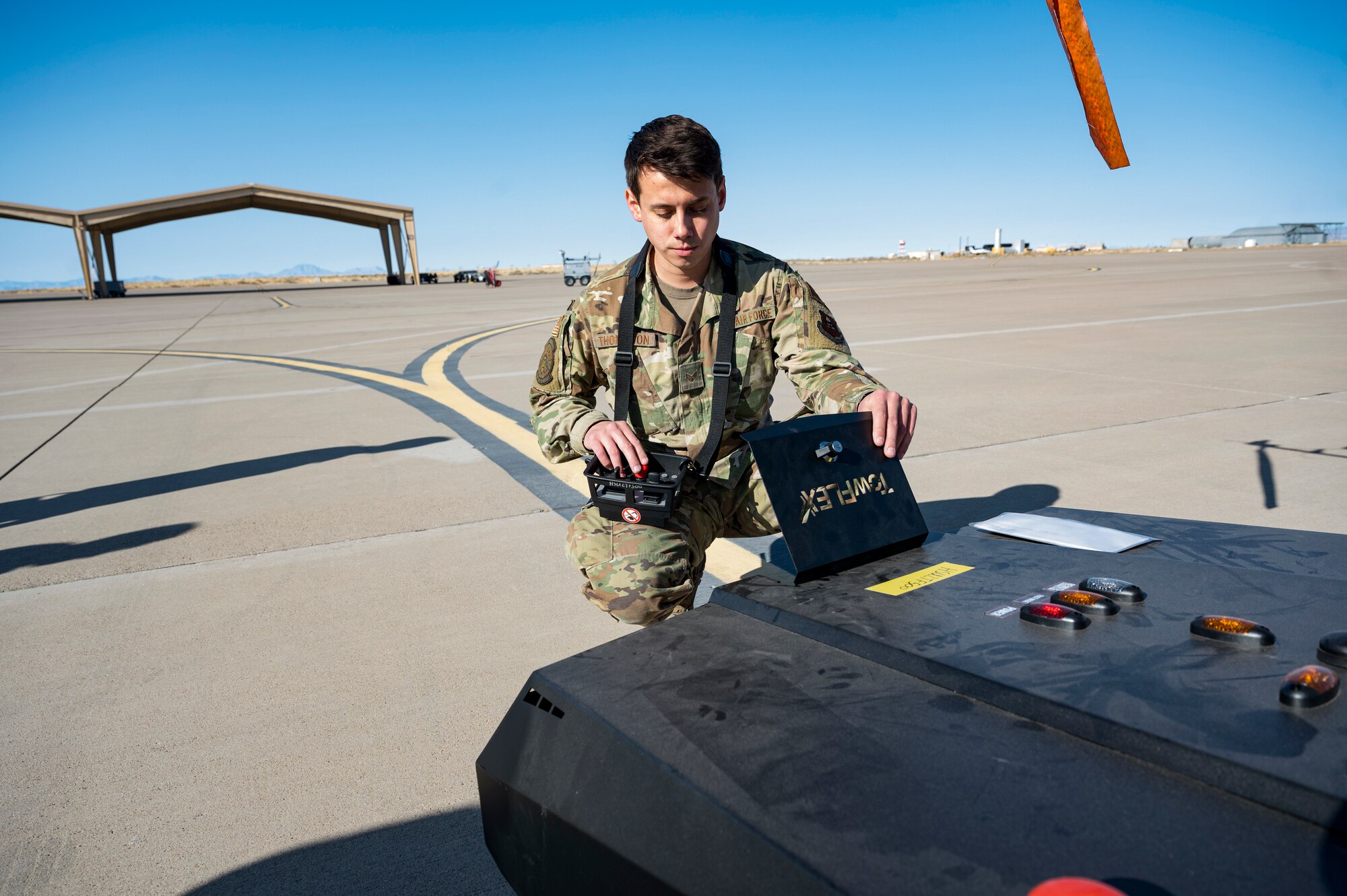 U.S. Air Force Senior Airman Alejandro Thompson, 29th Aircraft Maintenance Unit assistant dedicated crew chief, checks the battery charge of a TowFLEXX TF3 at Holloman Air Force Base, New Mexico, Dec. 15, 2022. The TF3 is a remote-controlled aircraft tug that is operated by one person, making it easy and efficient for the Airmen of the 29th AMU to operate. (U.S. Air Force photo by Airman 1st Class Isaiah Pedrazzini)