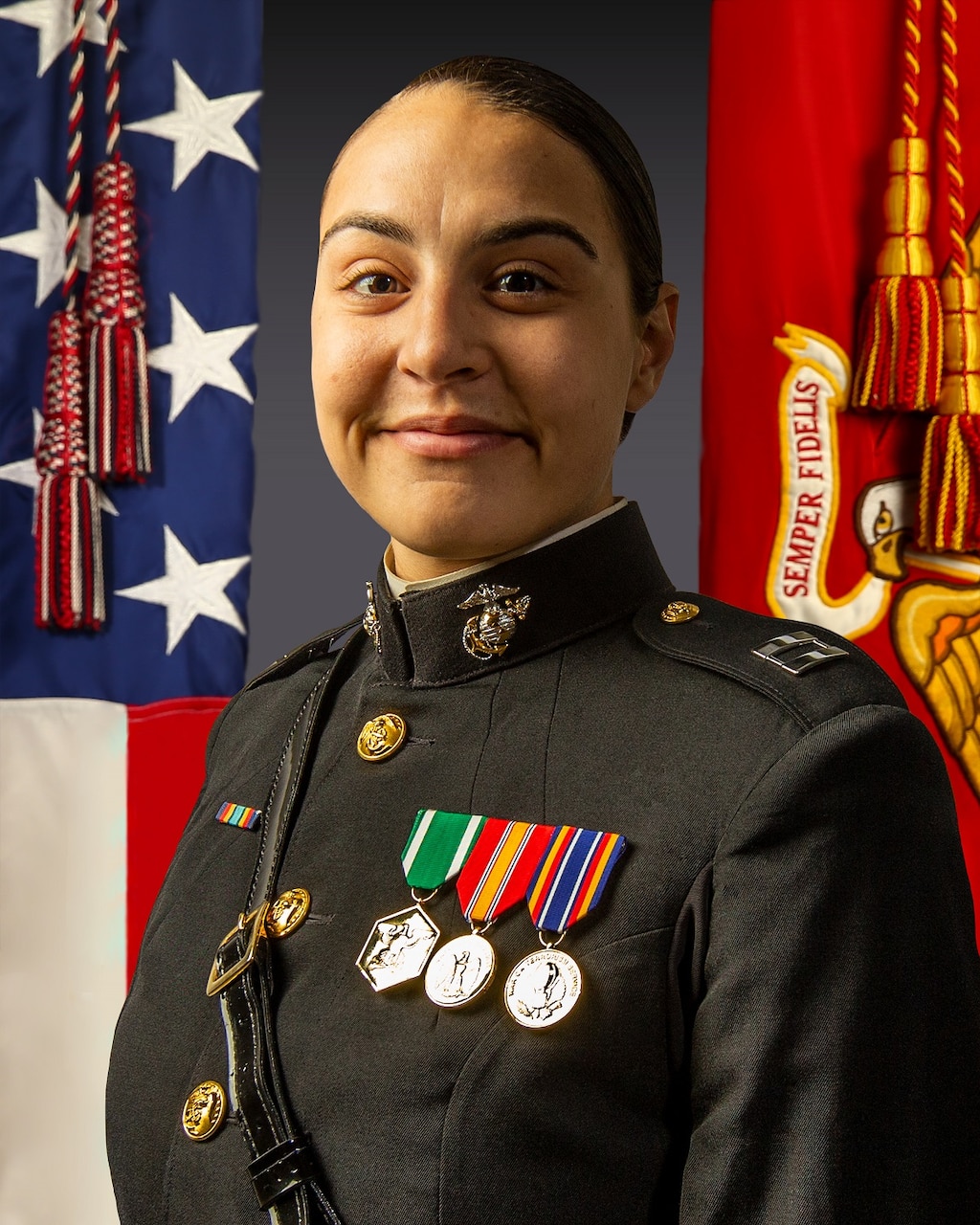 A woman in dress uniform poses for a photo.