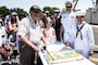 Naval Support Activity, Lakehurst, centennial attendees cut a cake at Joint Base McGuire-Dix-Lakehurst, N.J., June 25, 2021. The ceremony took place at Hangar No. 1, the first major facility built at Lakehurst and previously housed helium-filled dirigibles. Today, the hangar is home to the Center for Naval Aviation Technical Training and improves sailor’s general knowledge of launching aircraft.  (U.S. Air Force photo by Airman 1st Class Azaria E. Foster)