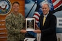 Christopher Burns, Navy Exchange Service Command senior vice president, presents U.S. Navy Capt. Frank T. Ingargiola, Joint Base McGuire-Dix-Lakehurst deputy commander and Naval Support Activity Lakehurst commander, the 2021 Bingham Award at Joint Base MDL, N.J., Oct. 18, 2022. Navy Exchange Lakehurst received the award in the sales over $1.4 to $2.2 million category. The award is presented to the best NEX in nine sales categories for overall financial results and customer service. (U.S. Air Force photo by Airman 1st Class Sergio Avalos)