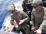 Chief Petty Officer Joseph Greely (left) from Coast Guard Cutter Charles Moulthrope instructs then Petty Officer 1st Class Collin Strange as they conduct training in the cutter’s small boat in the Atlantic on April 12, 2021. Strange, an operations specialist, is the winner of the 2022 Hopley Yeaton Enlisted Officer Superior Cutterman award. (U.S. Coast Guard photo by Petty Officer 1st Class Sydney Niemi/Released)