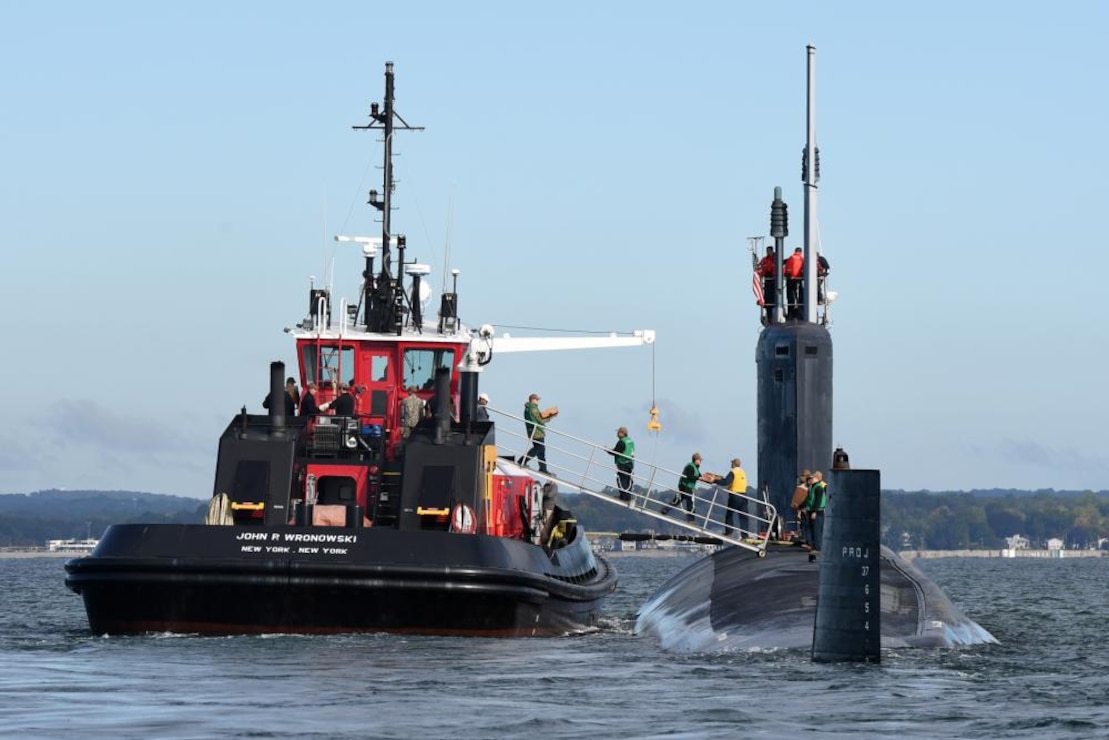 The USS Oregon (SSN 793) conducts a supplies onload with tug boat John P. Wronowski in the mouth of Thames River in Groton, Conn., Oct. 6. The Virginia-class fast attack submarine USS Oregon and crew operate under Submarine Squadron (SUBRON) FOUR and its primary mission is to provide attack submarines that are ready, willing, and able to meet the unique challenges of undersea combat and deployed operations in unforgiving environments across the globe.