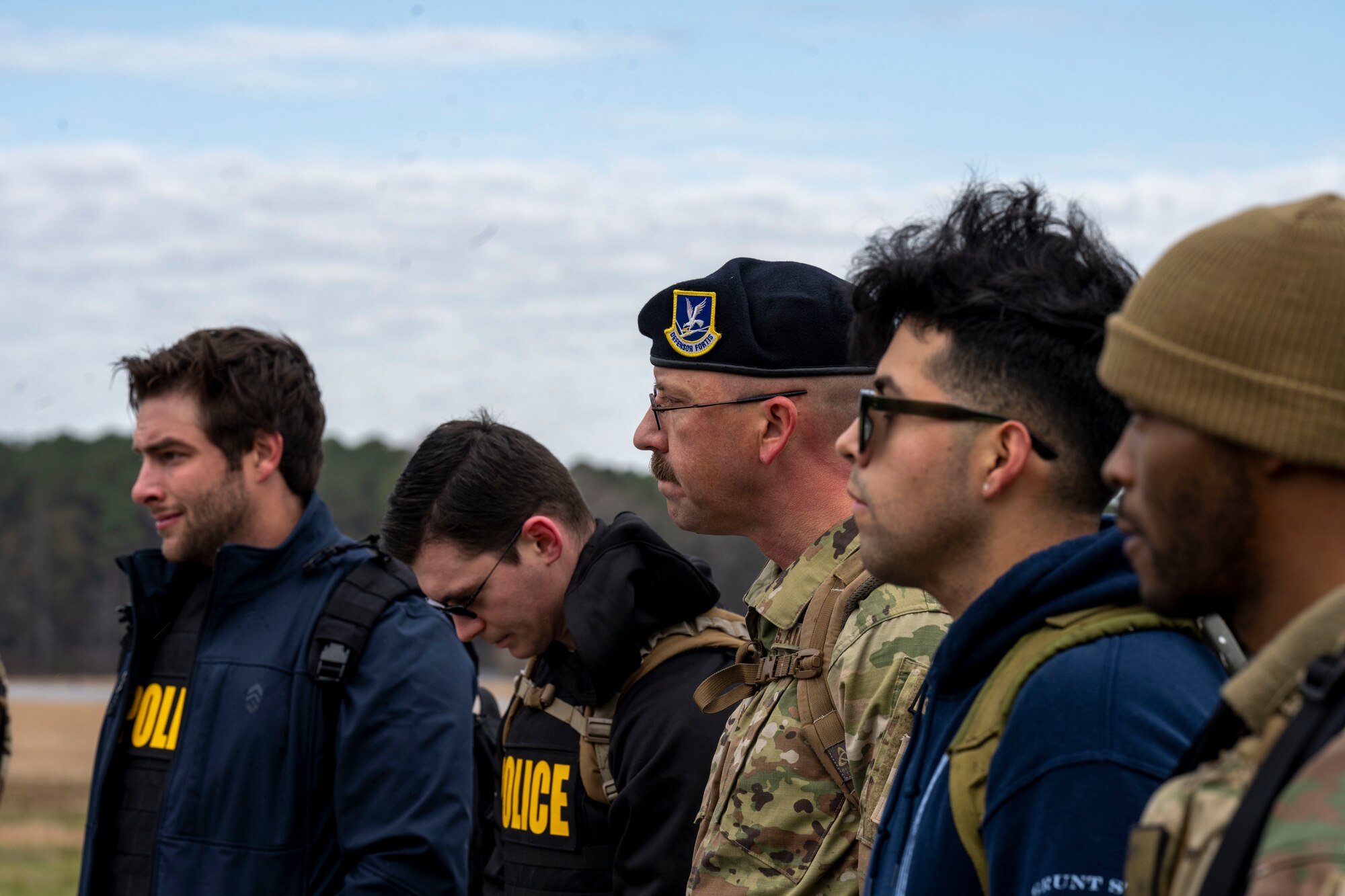 Airmen assigned to the 4th Fighter Wing and Air Force Office of Special Investigation Detachment 216 stop on the second mile of the six-mile ruck to remember members of Task Force Crimson “Hustler 6” that lost their lives on Dec. 21, 2015 at Seymour Johnson Air Force Base, North Carolina, Dec. 21, 2022. On that day, a suicide bomber detonated an improvised explosive device killing Special Agents Adrianna Vorderbruggen, Michael Cinco, Peter Taub, Chester McBride, and Security Forces defenders Technical Sgt. Joseph Lemm and Staff Sgt. Louis Bonacasa.  (U.S. Air Force photo by Senior Airman Kevin Holloway)