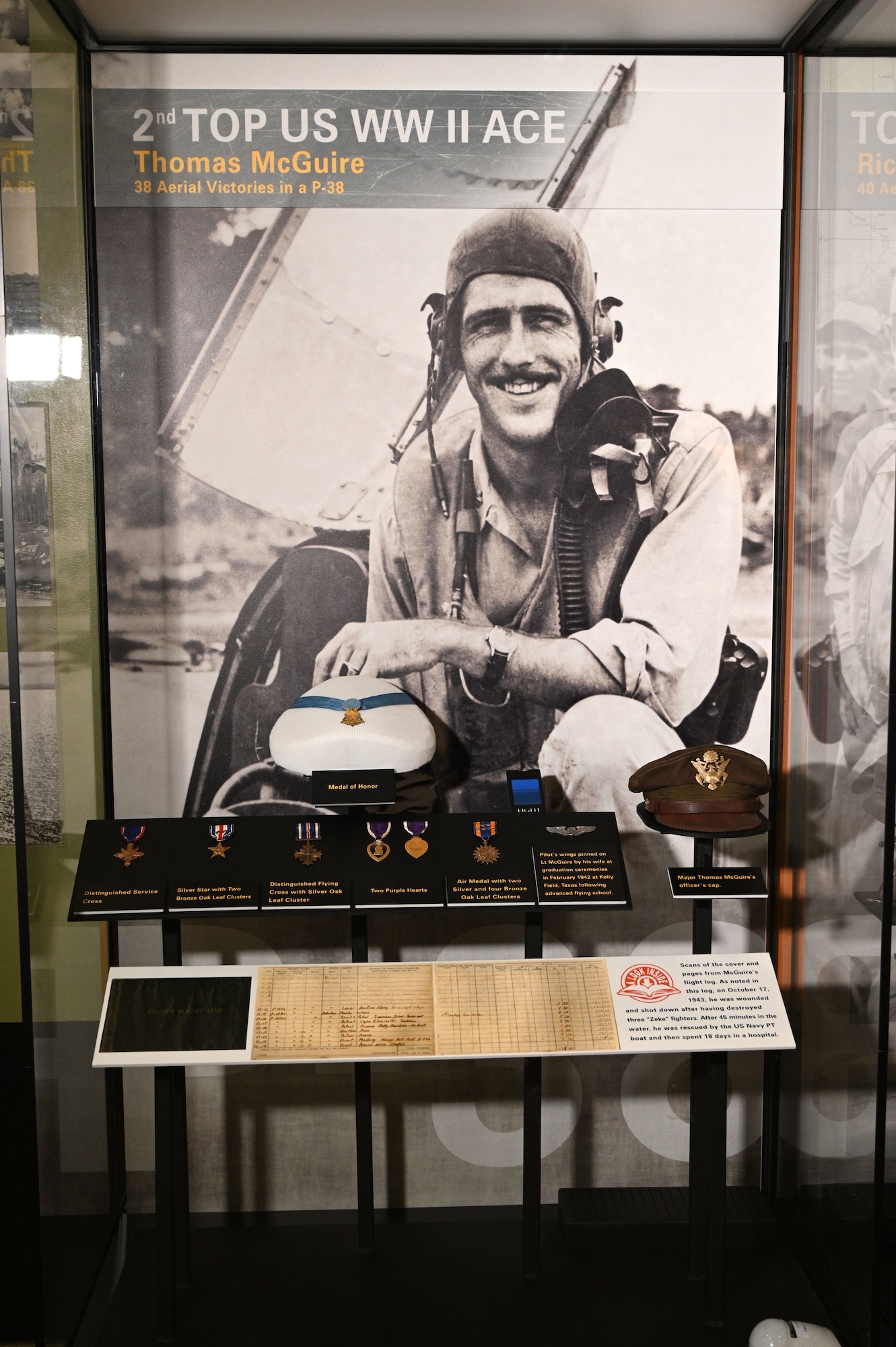 Display case featuring items from Maj. Thomas B. McGuire Jr. that includes pilot wings, air medals and the Medal of Honor from WWII.