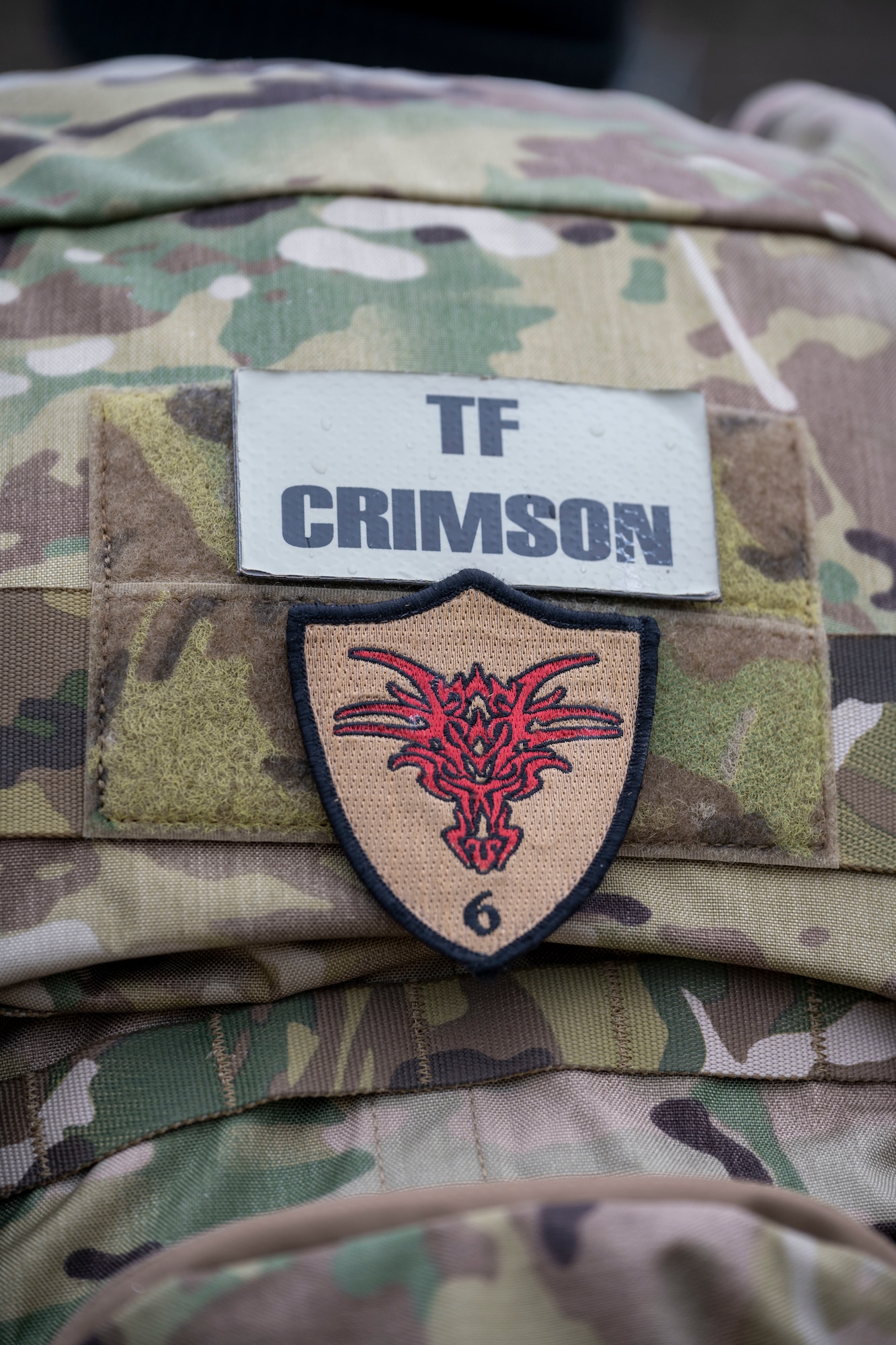 Master Sgt. Kyle Henderson, 4th Security Forces Squadron NCO in-charge of weapons and tactics, wore a backpack that displayed the Task Force Crimson patch and Hustler 6 patch, during a six-mile ruck at Seymour Johnson Air Force Base, North Carolina, Dec. 21, 2022. The ruck was in remembrance of those assigned to Task Force Crimson “Hustler 6” who lost their lives on Dec. 21, 2015, to a motorcyclist who detonated an Improvised explosive device claiming the lives of four Air Force Office of Special Investigations agents and two Security Forces defenders. (U.S. Air Force photo by Senior Airman Kevin Holloway)