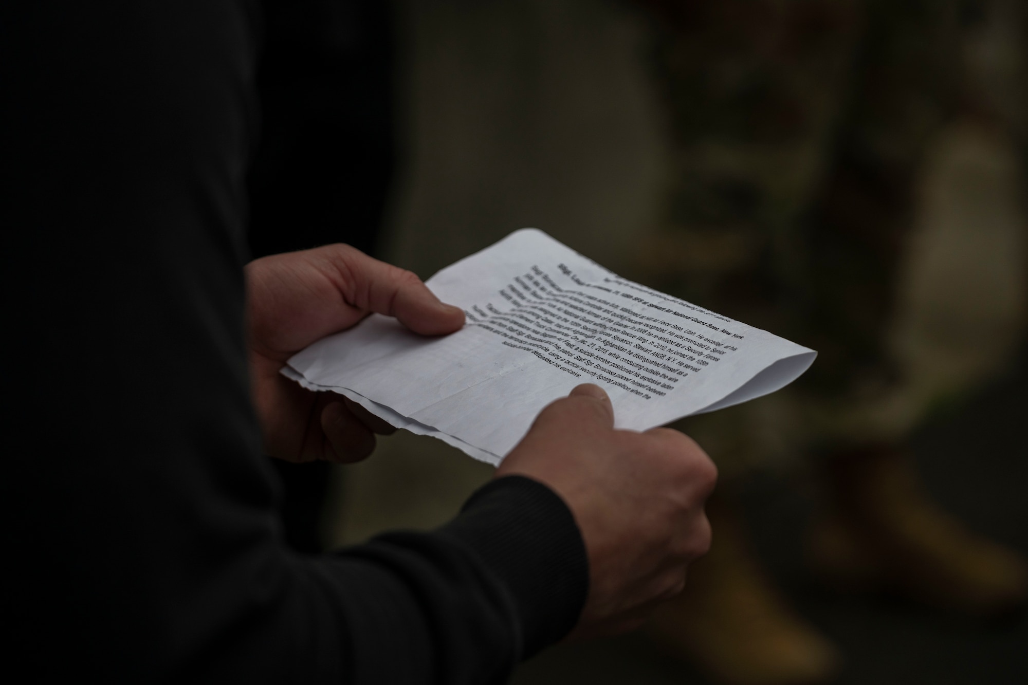 Airman 1st Class Jonathan Scott, 4th Security Forces Squadron installation entry controller, reads the final passage at the end of a six-mile ruck at Seymour Johnson Air Force Base, North Carolina, Dec. 22, 2022. The passage was in remembrance of Staff Sgt. Louis Bonacasa who died on Dec. 21, 2015, after a motorcyclist detonated an improvised explosive device outside of Bagram Air Field, Afghanistan. (U.S. Air Force photo by Senior Airman Kevin Holloway)