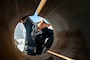 Airman Tyler Heston, from Fairfield, Iowa, sands a water brake cylinder aboard the Nimitz-class aircraft carrier USS Dwight D. Eisenhower (CVN 69). Ike is currently pierside at Norfolk Naval Shipyard in the basic phase of the optimized fleet response plan (OFRP).