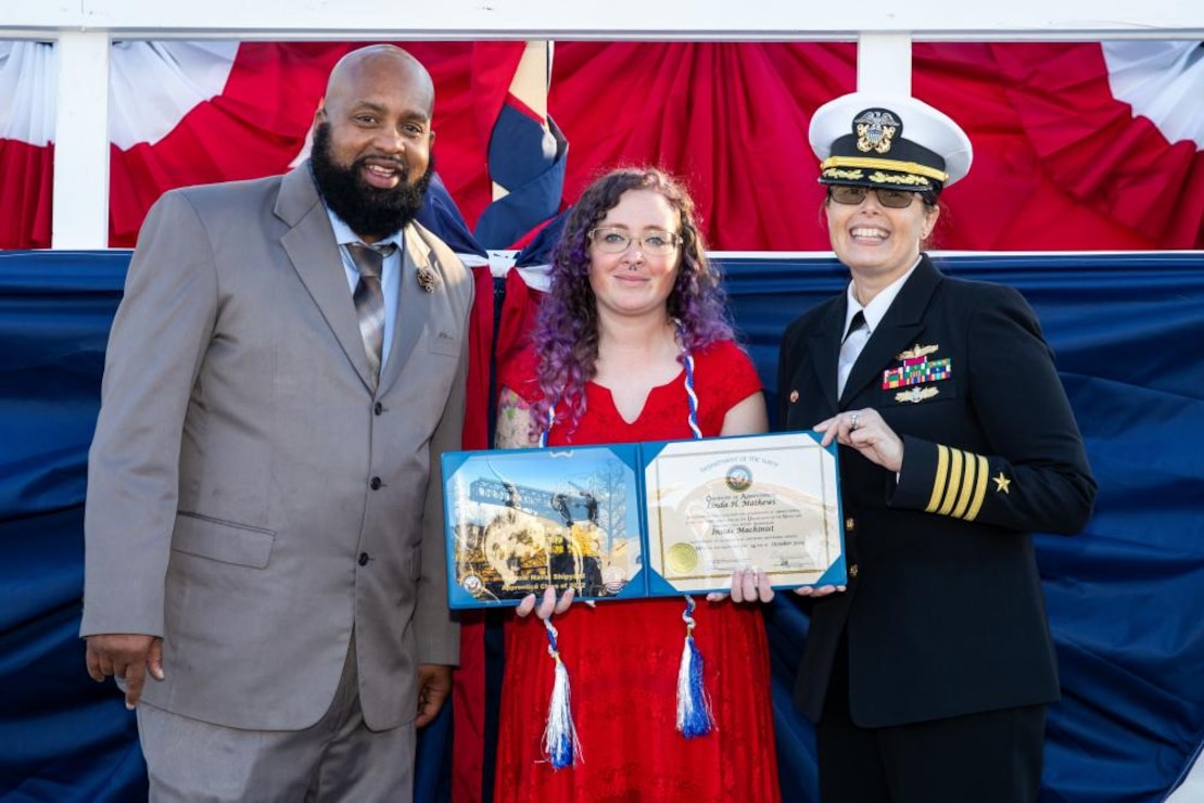 From left to right: Norfolk Naval Shipyard Apprentice Director Colby Tynes, 2022 Apprentice valedictorian and Shop 31 Inside Machinist Linda Matthews, and Shipyard Commander Capt. Dianna Wolfson.