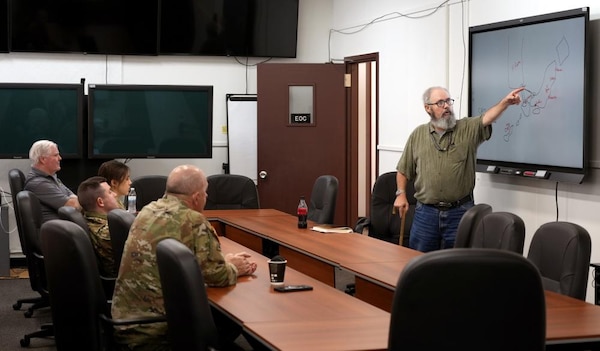 Dave Puckett, Japan Engineer District’s Chief of the Security Plans Operations Office, gestures toward a white board, working out the game plan as part of the Japan Engineer District's "walk, run, crawl" plan as they ramp up to take part in Exercise 2025.