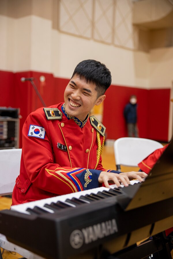 A musician with the Republic of Korea Army Band performs for attendees during a holiday celebration on Camp Mujuk, Republic of Korea, Dec. 15, 2022. Camp Mujuk invited local Korean children from Sunrin Aeyukwon, Pohang City Dream Start, and Dasom Children’s Center to join them for a holiday celebration. Marines and base personnel organized food and entertainment were organized for the event and the night ended with a tree lighting ceremony. (U.S. Marine Corps photo by Lance Cpl. Thomas Sheng)