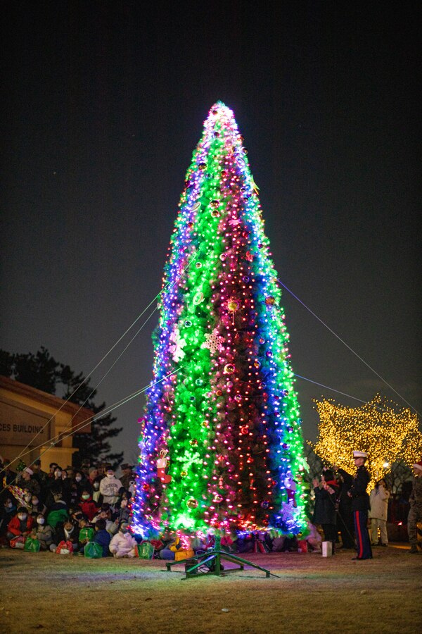A tree is lit during a holiday celebration on Camp Mujuk, Republic of Korea, Dec. 15, 2022. Camp Mujuk invited local Korean children from Sunrin Aeyukwon, Pohang City Dream Start, and Dasom Children’s Center to join them for a holiday celebration. Marines and base personnel organized food and entertainment were organized for the event and the night ended with a tree lighting ceremony. (U.S. Marine Corps photo by Lance Cpl. Thomas Sheng)