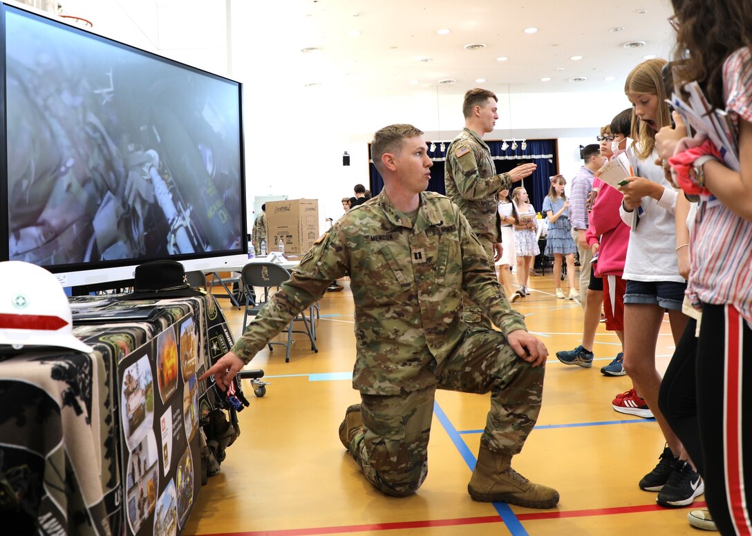 U.S. Army Capt. Will Mengon explains the U.S. Army Corp of Engineers mission to Yokota Middle School students during a Career Fair at Yokota Middle School.