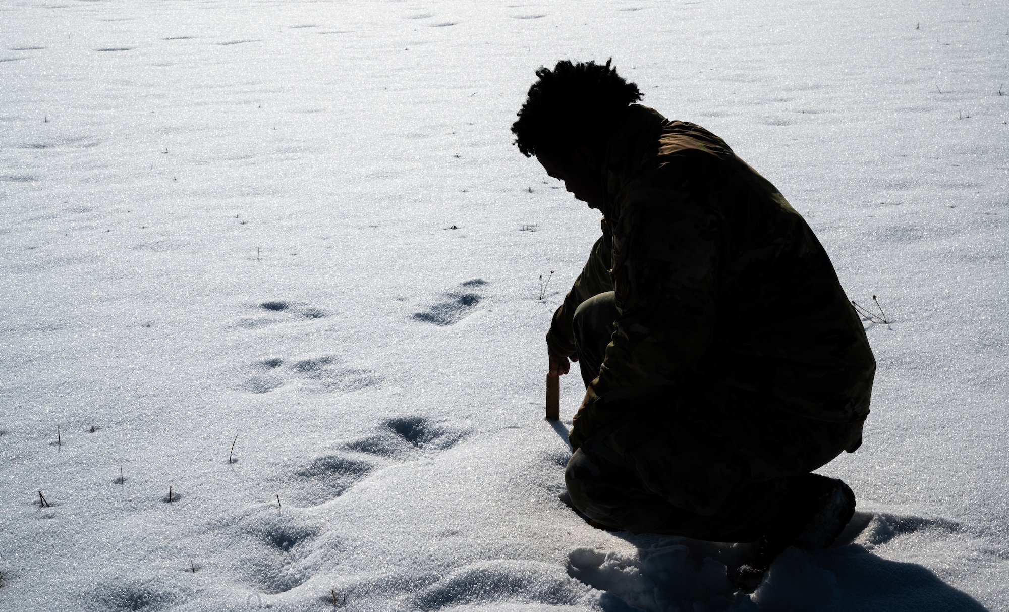 Senior Airman Patrick Bell, 8th Operations Support Squadron weather forecaster, analyzes the snow at Kunsan Air Base, Republic of Korea, Dec. 27, 2022. Working 24-hour operations, Kunsan’s weather flight takes readings every eight hours to adjust and update their forecasts and keep the installation safe with accurate information. (U.S. Air Force photo by Staff Sgt. Sadie Colbert)