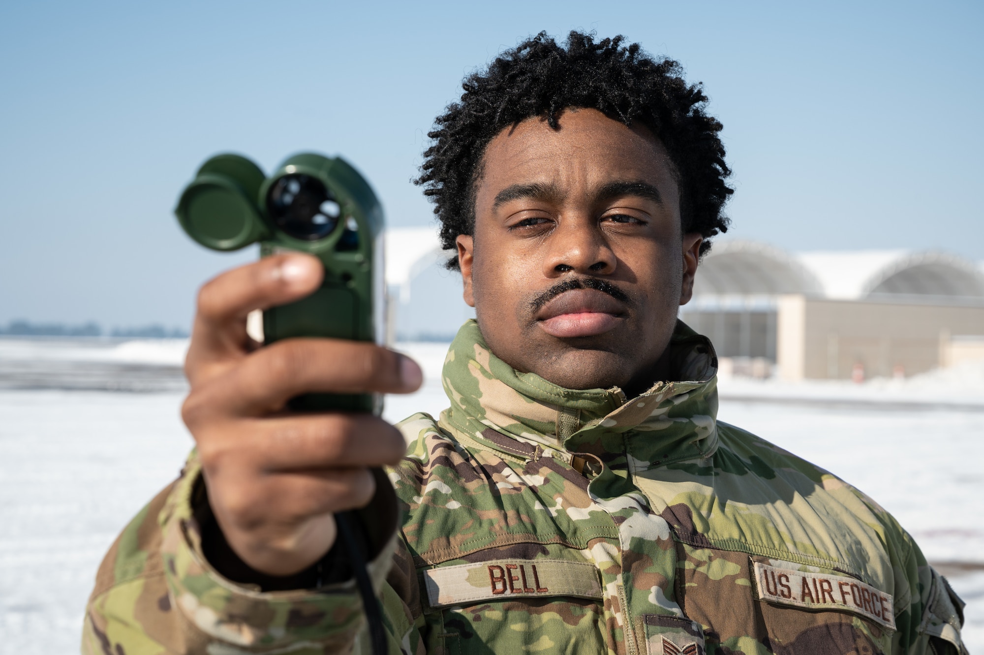 Senior Airman Patrick Bell, 8th Operations Support Squadron weather forecaster, uses a kestrel, at Kunsan Air Base, Republic of Korea, Dec. 27, 2022. Kestrels read windspeed, temperature, humidity, heat stress conditions and barometric pressure, all factors that impact personnel and machinery. (U.S. Air Force photo by Staff Sgt. Sadie Colbert)