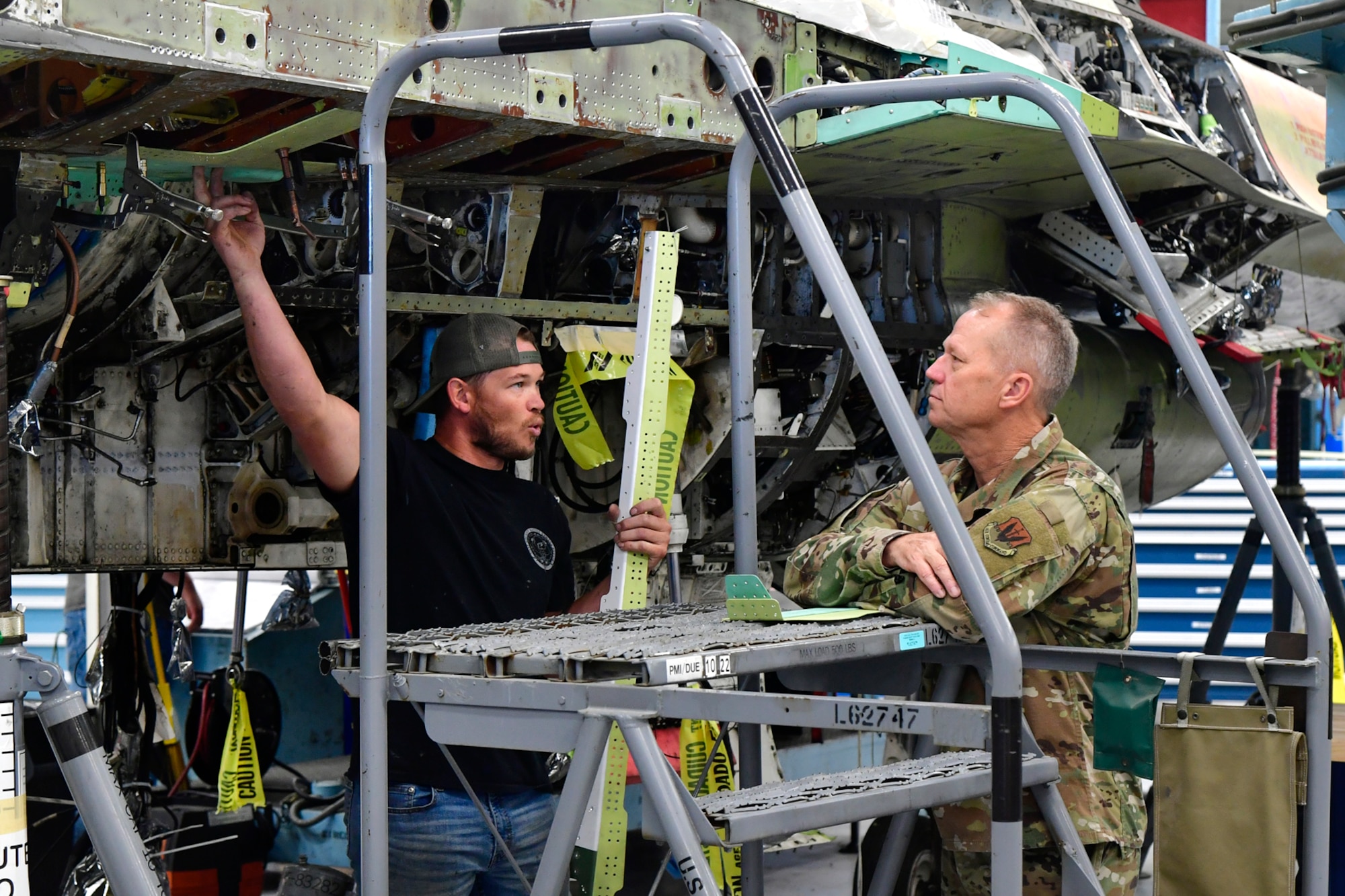 An aircraft maintenance worker talks with AFMC top leader.
