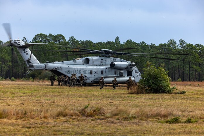 U.S. Marines with Battalion Landing Team, 1st Battalion, 6th Marine Regiment, 2nd Marine Division, exit a CH-53E Super Stallion helicopter during a Raid Course on Marine Corps Base Camp Lejeune, North Carolina, Nov. 30, 2022. The Raid was one of several training events part of Marine Air Ground Task Force Interoperability Course, an Expeditionary Operations Training Group led training and evaluation event focused on combining elements of the MAGTF during the initial training phases of the 26th Marine Expeditionary Unit Pre-deployment training program.
