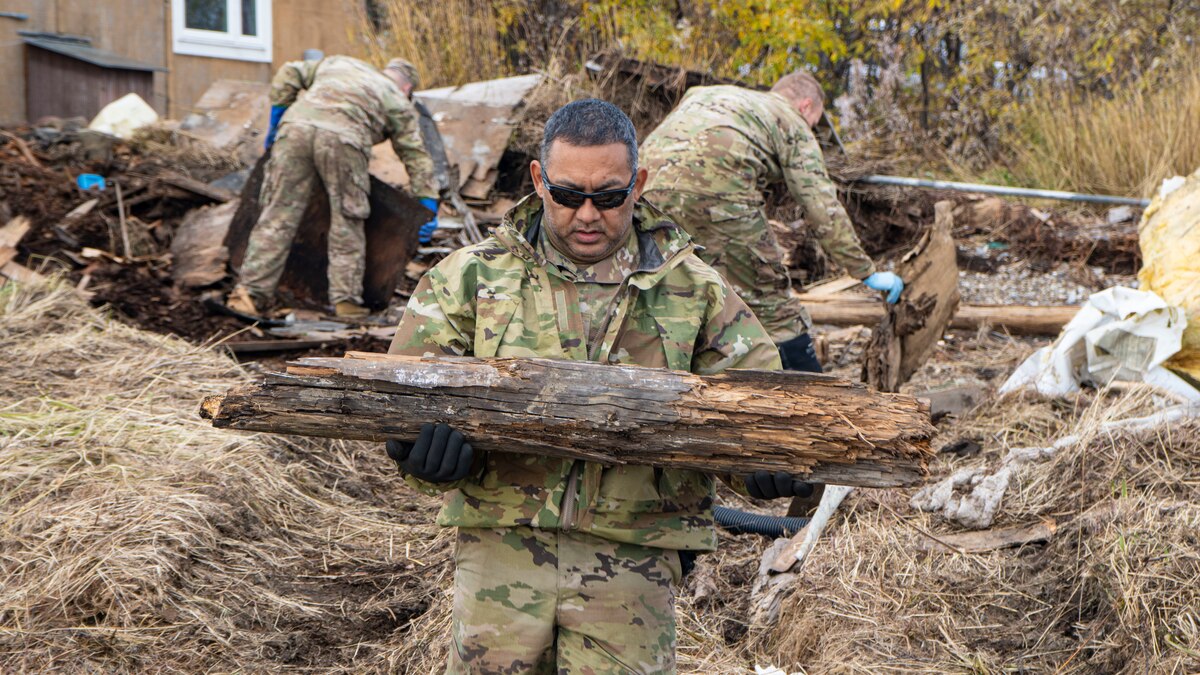 Alaska Air National Guard Tech Sgt. Robert Wolford, a metals technician assigned to the 168th Maintenance Squadron, cleans up debris as part of Operation Merbok Response in Koyuk, Alaska, Sept. 27, 2022. Remnants of Typhoon Merbok caused dramatic flooding across more than 1,000 miles of Alaskan coastline.