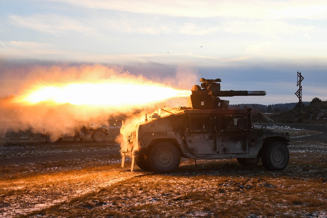 A military tank fires a missile.