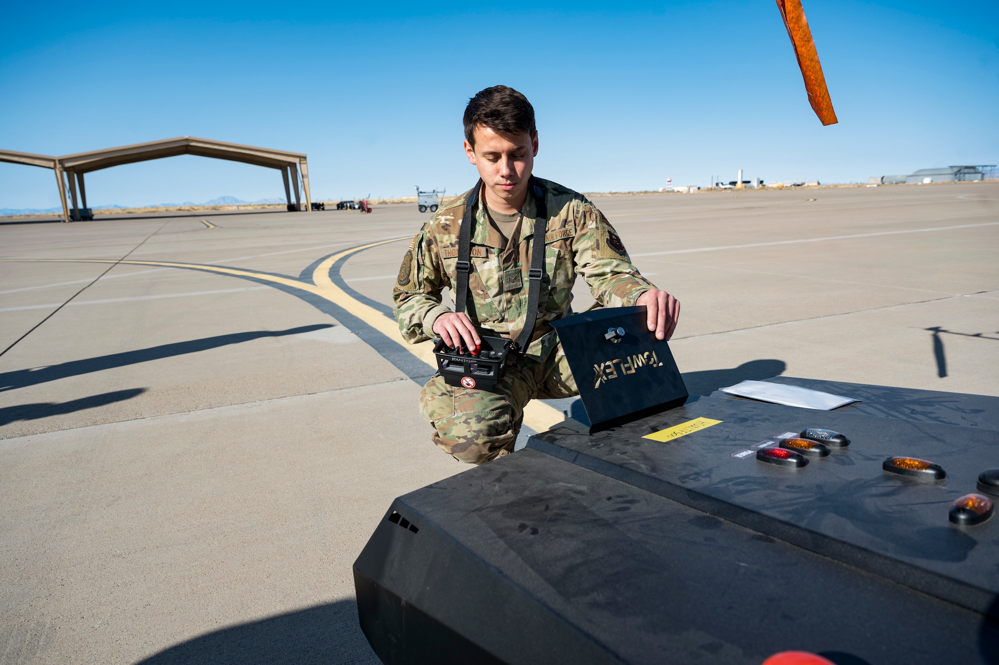 U.S. Air Force Senior Airman Alejandro Thompson, 29th Aircraft Maintenance Unit assistant dedicated crew chief, checks the battery charge of a TowFLEXX TF3 at Holloman Air Force Base, New Mexico, Dec. 15, 2022. The TF3 is a remote-controlled aircraft tug that is operated by one person, making it easy and efficient for the Airmen of the 29th AMU to operate. (U.S. Air Force photo by Airman 1st Class Isaiah Pedrazzini)