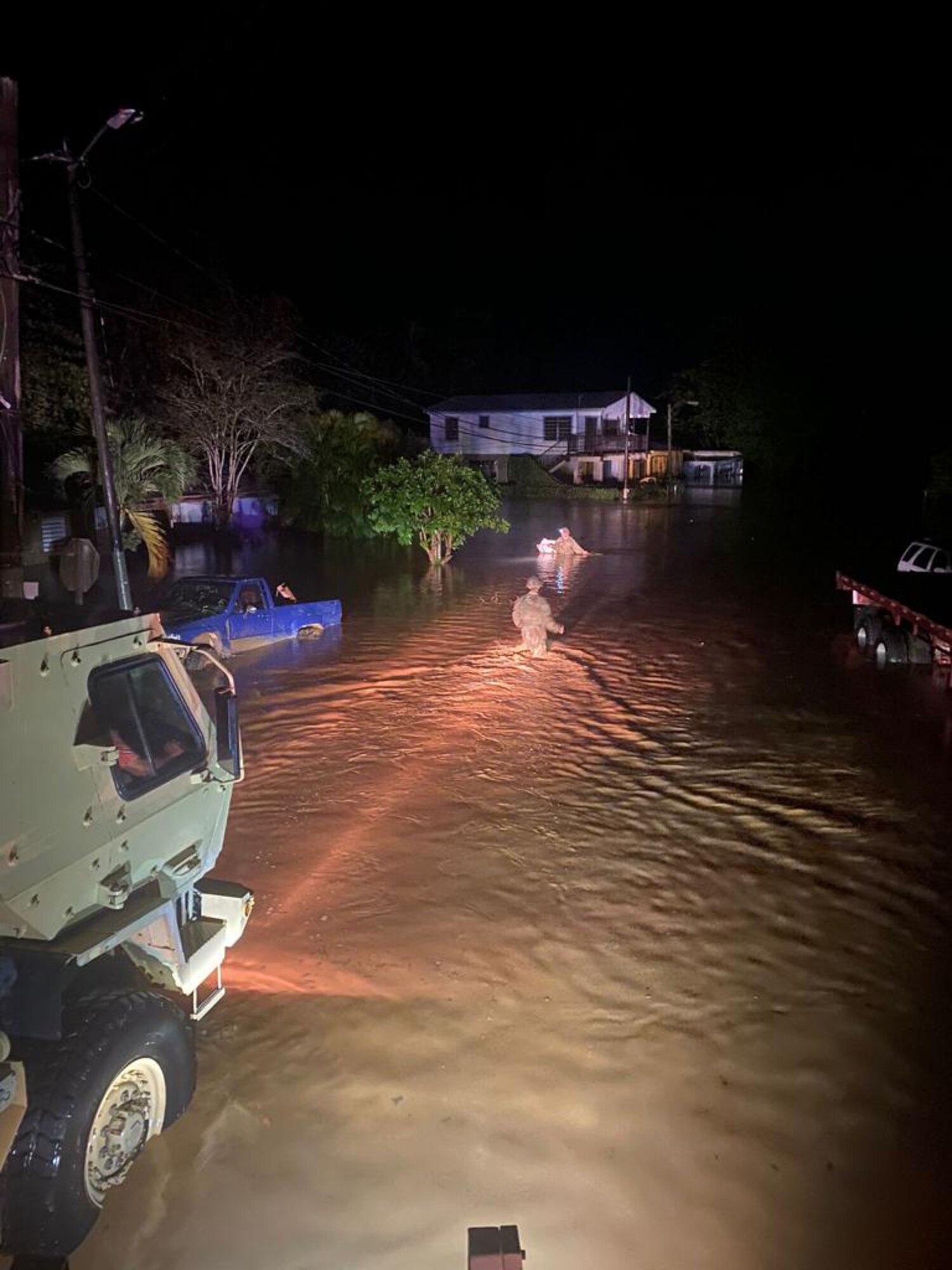 Puerto Rico National Guard Soldiers from the 125th Military Police Battalion help rescue families trapped by floods during the passing of Hurricane Fiona Sept. 19, 2022.