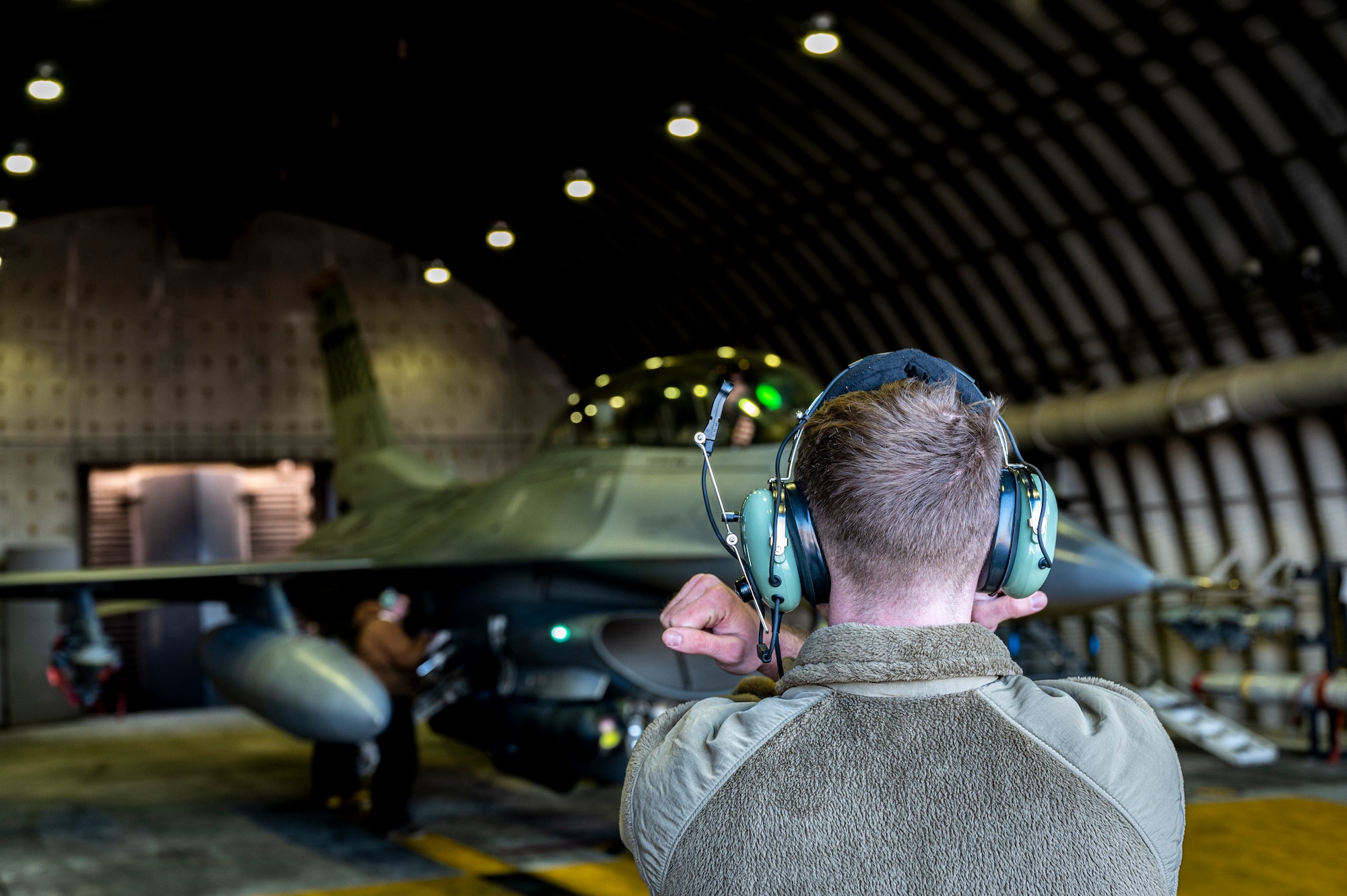 U.S Air Force Staff Sgt. Joseph Weber, 36th Fighter Generation Squadron aerospace propulsion technician signals an F-16 Fighting Falcon pilot during pre-flight checks at Osan Air Base, Republic of Korea, Dec. 28, 2022.