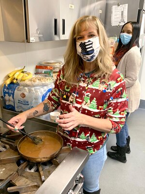 Michelle Groat prepares gravy at stove