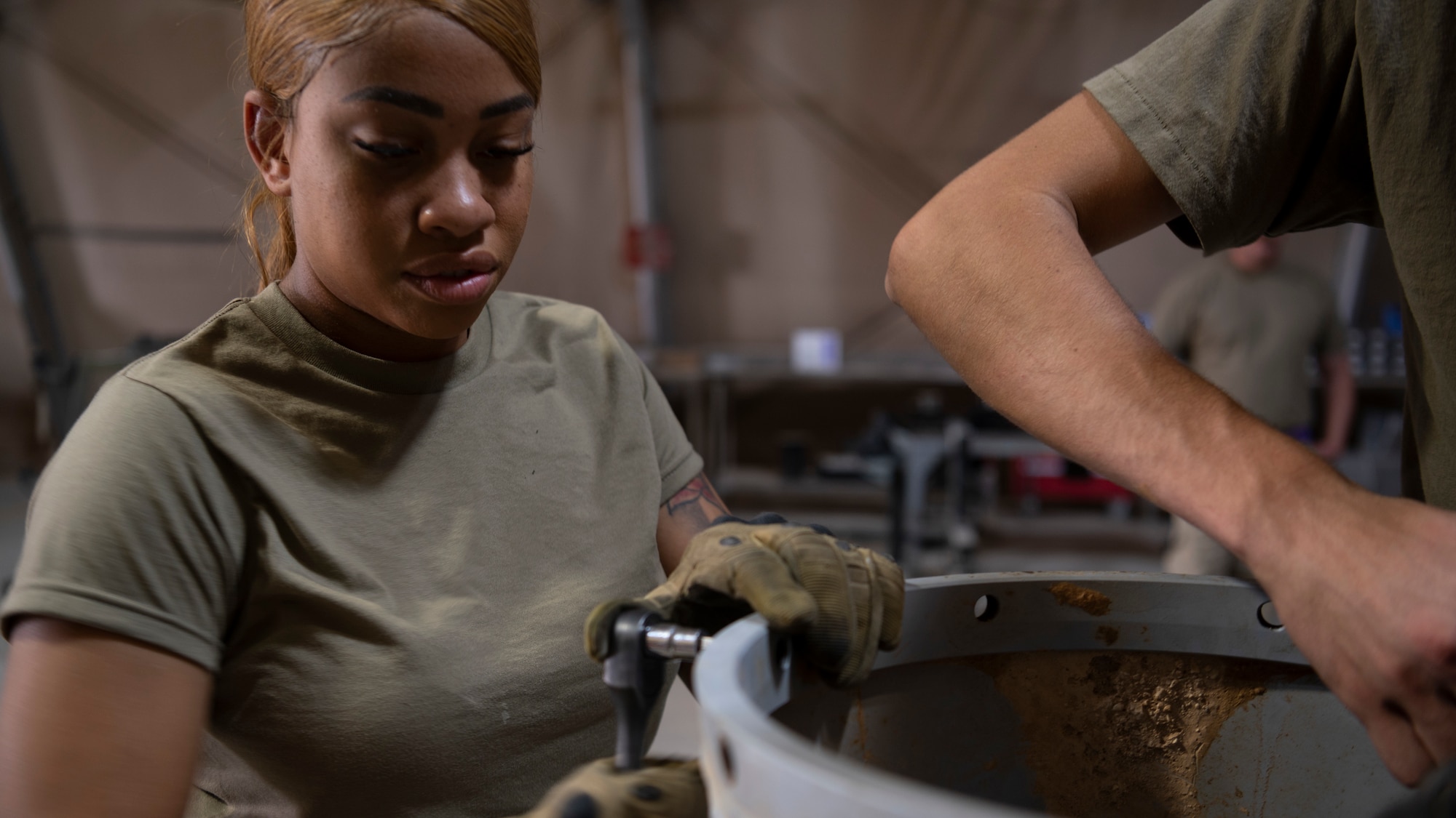 U.S. Air Force Staff Sgt. Yacobayah Cooper, 332d Expeditionary Maintenance Squadron, Munitions Flight, Conventional Maintenance Inspector, uses a socket wrench to assemble the tail section of an MK-84 conical bomb. These bombs are capable of penetrating up to 11 feet of concrete and spreading shrapnel in a 400 yard radius. (U.S. Air Force photo by: Tech. Sgt. Jeffery Foster)