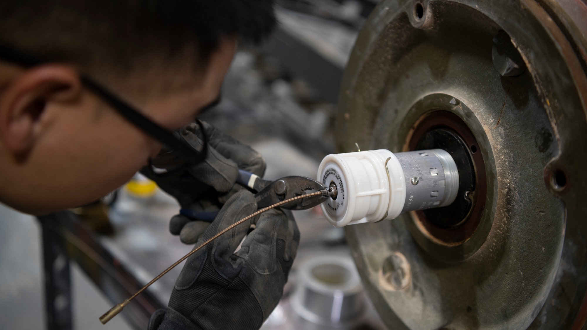 A Munitions Systems specialist with the 332d Expeditionary Maintenance Squadron, Munitions Flight, assembles the tail section of an MK-84 conical bomb. These bombs are capable of penetrating up to 11 feet of concrete and spreading shrapnel in a 400 yard radius. (U.S. Air Force photo by: Tech. Sgt. Jeffery Foster)